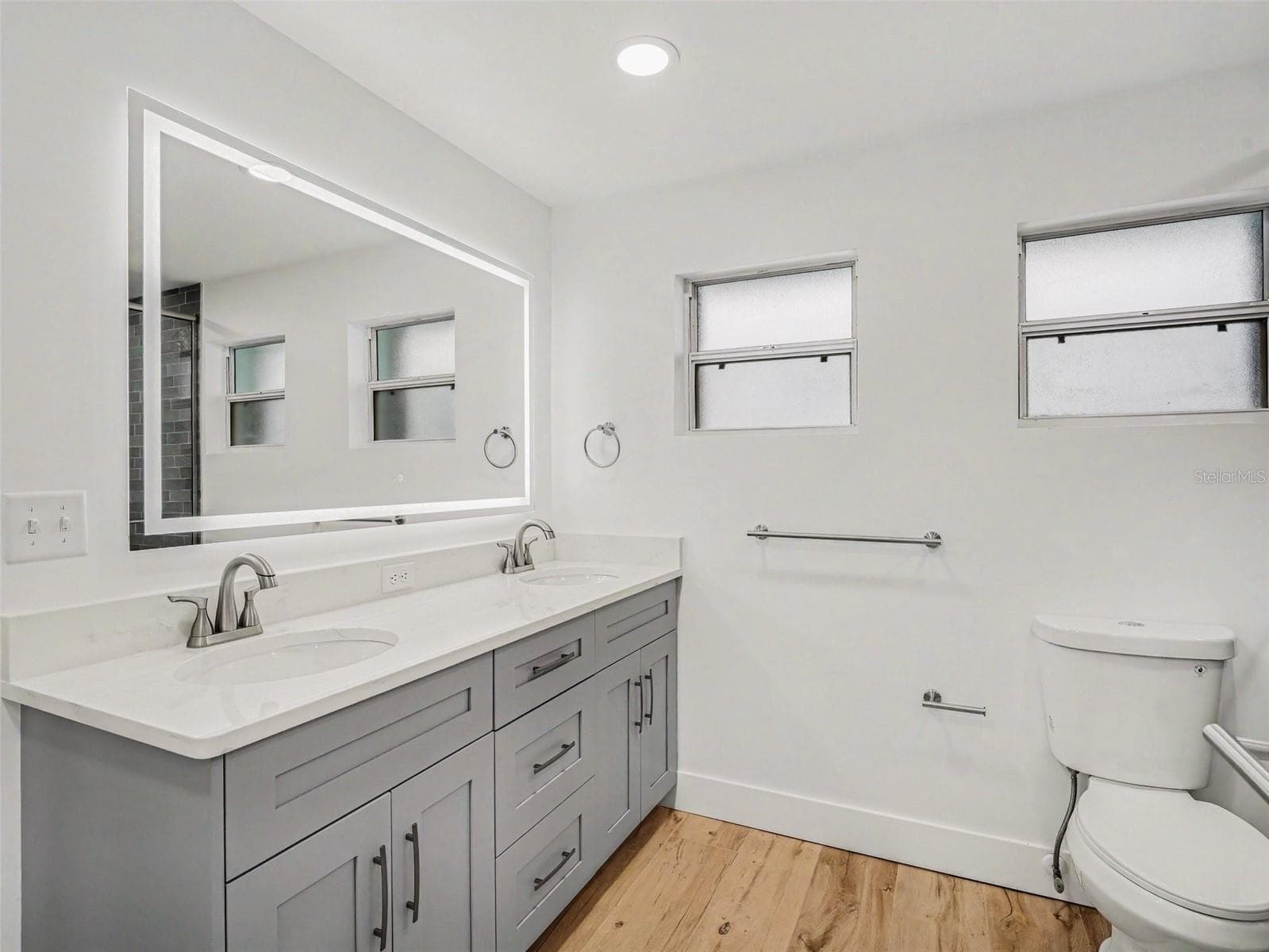 Primary bathroom has dual sinks and LED lighted mirror - 548 BELVEDERE CT, PUNTA GORDA