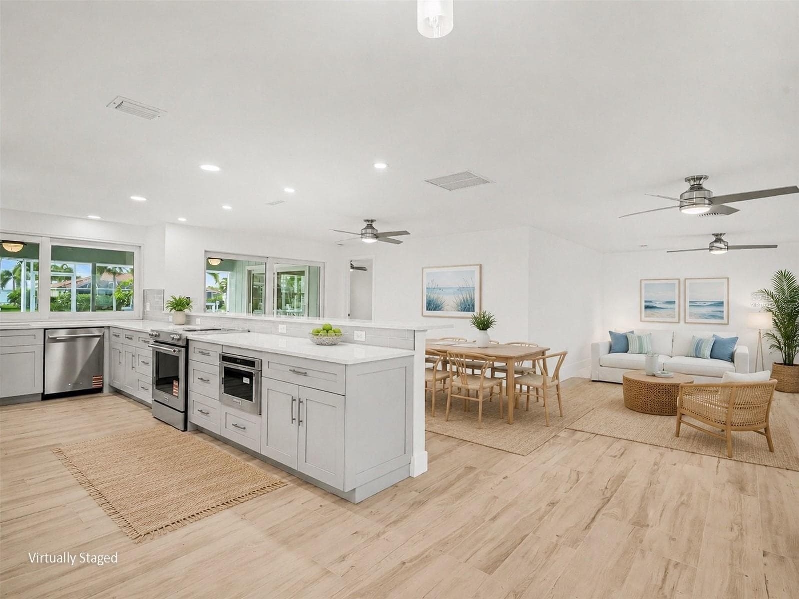 Open floor plan is great for entertaining - kitchen/dining room/living room, all opening up to lanai (virtually staged) - 548 BELVEDERE CT, PUNTA GORDA