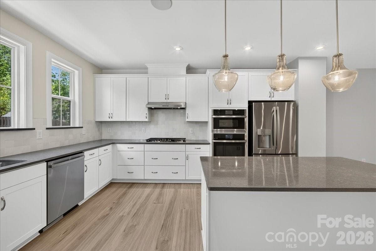 Light filled gourmet kitchen with large island - 232 Old Town Village Road, Waxhaw