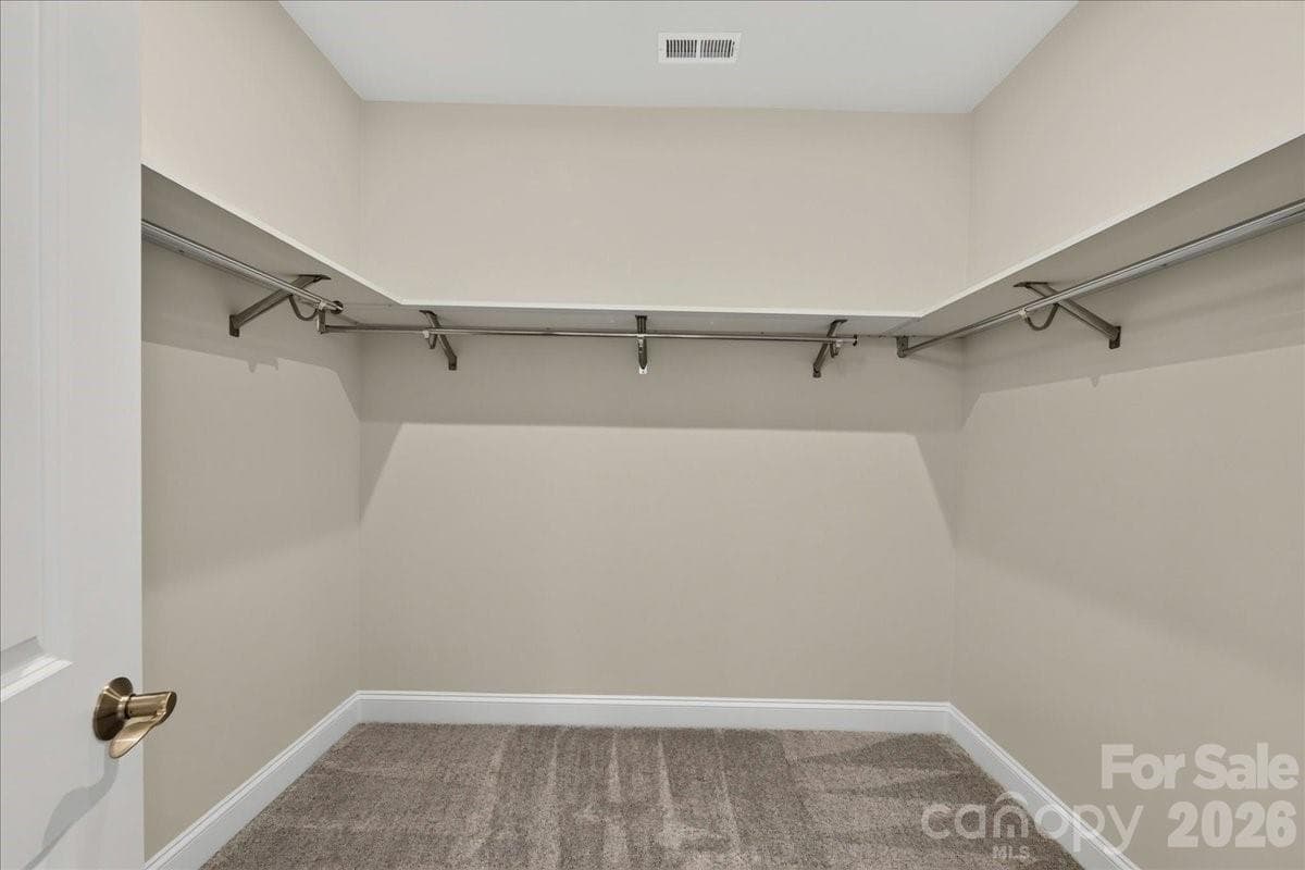 Primary walk-in closet with upgraded shelving - 232 Old Town Village Road, Waxhaw