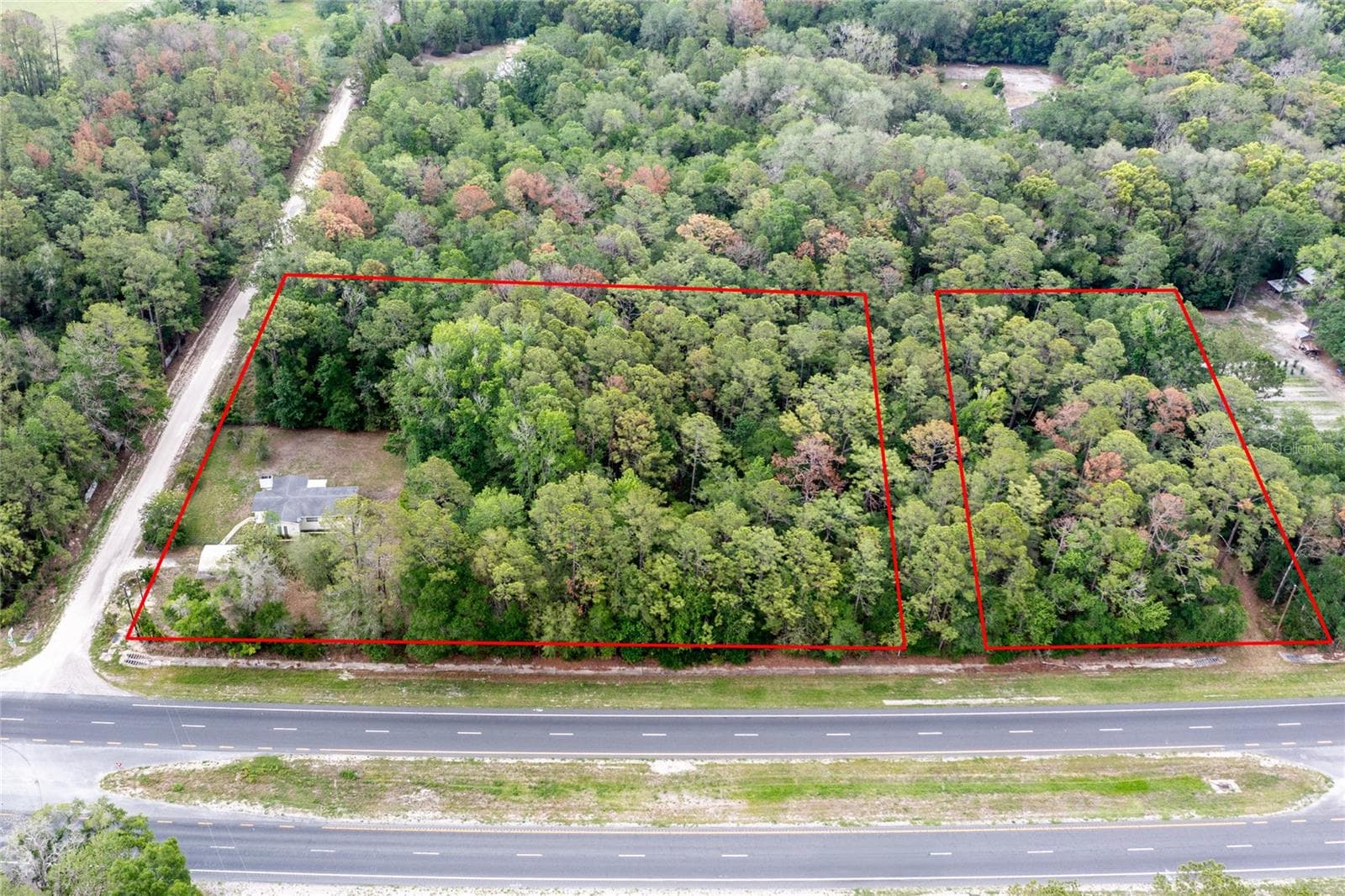This aerial shows the entire 5.58 acres in two red outlined parcels - 16913 NE 77TH LN, HAWTHORNE