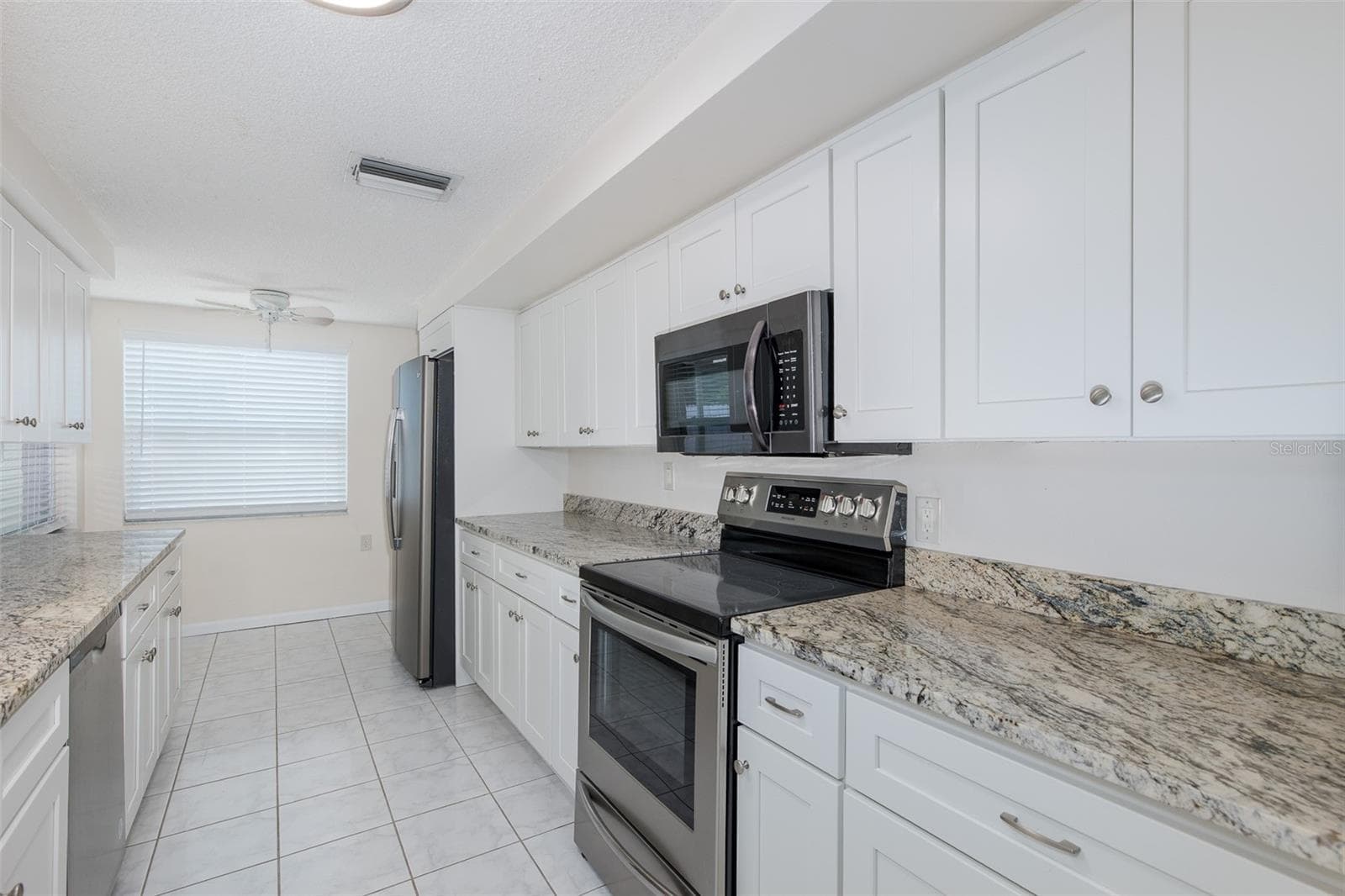 Galley Kitchen with Granite - 1148 FERNWOOD DR, HOLIDAY