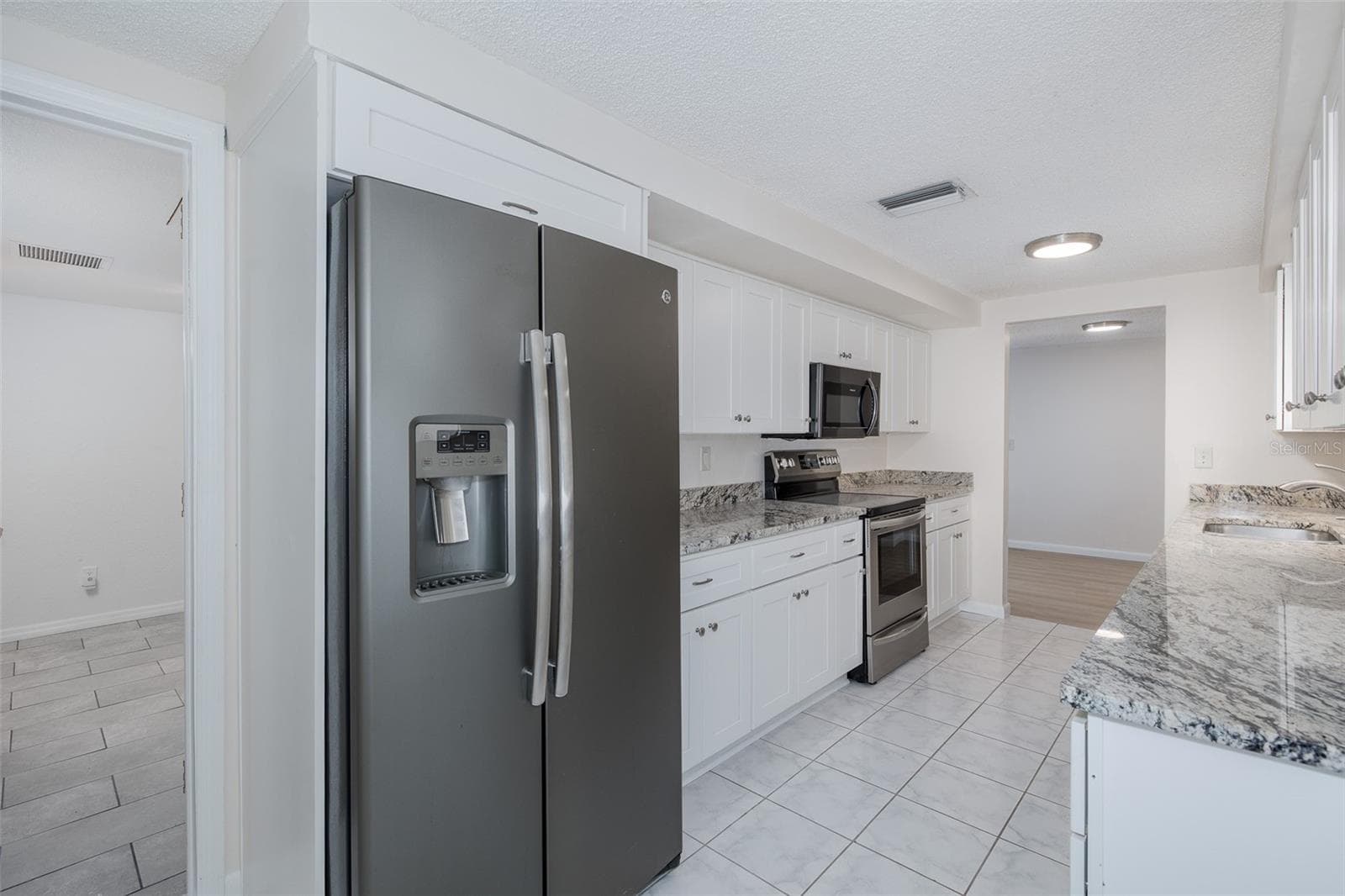 Galley Kitchen with Granite - 1148 FERNWOOD DR, HOLIDAY