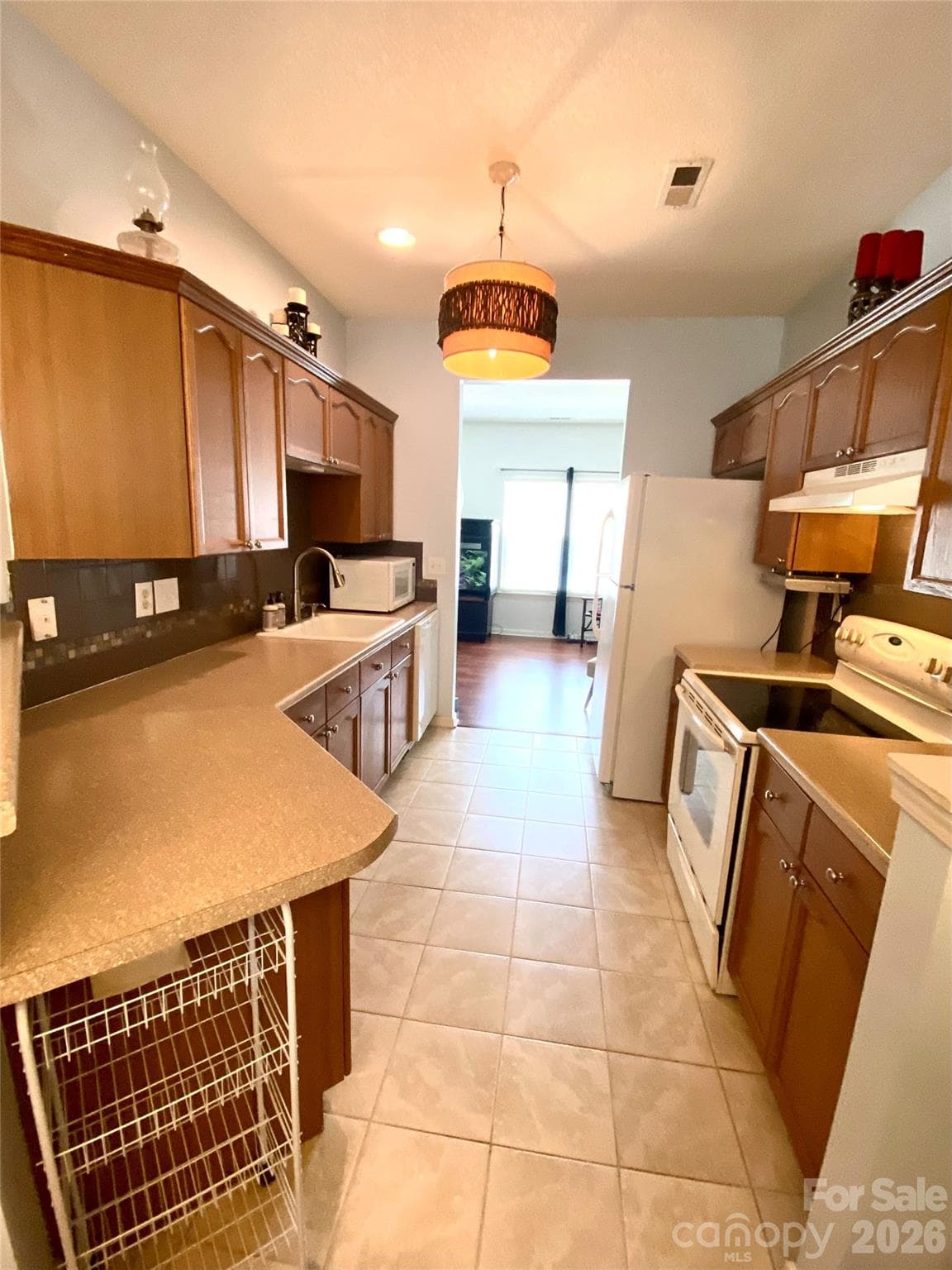 Kitchen view from Dining area with lots of counter space and brushed nickel, goose neck faucet. - 6025 Creft Circle, Indian Trail