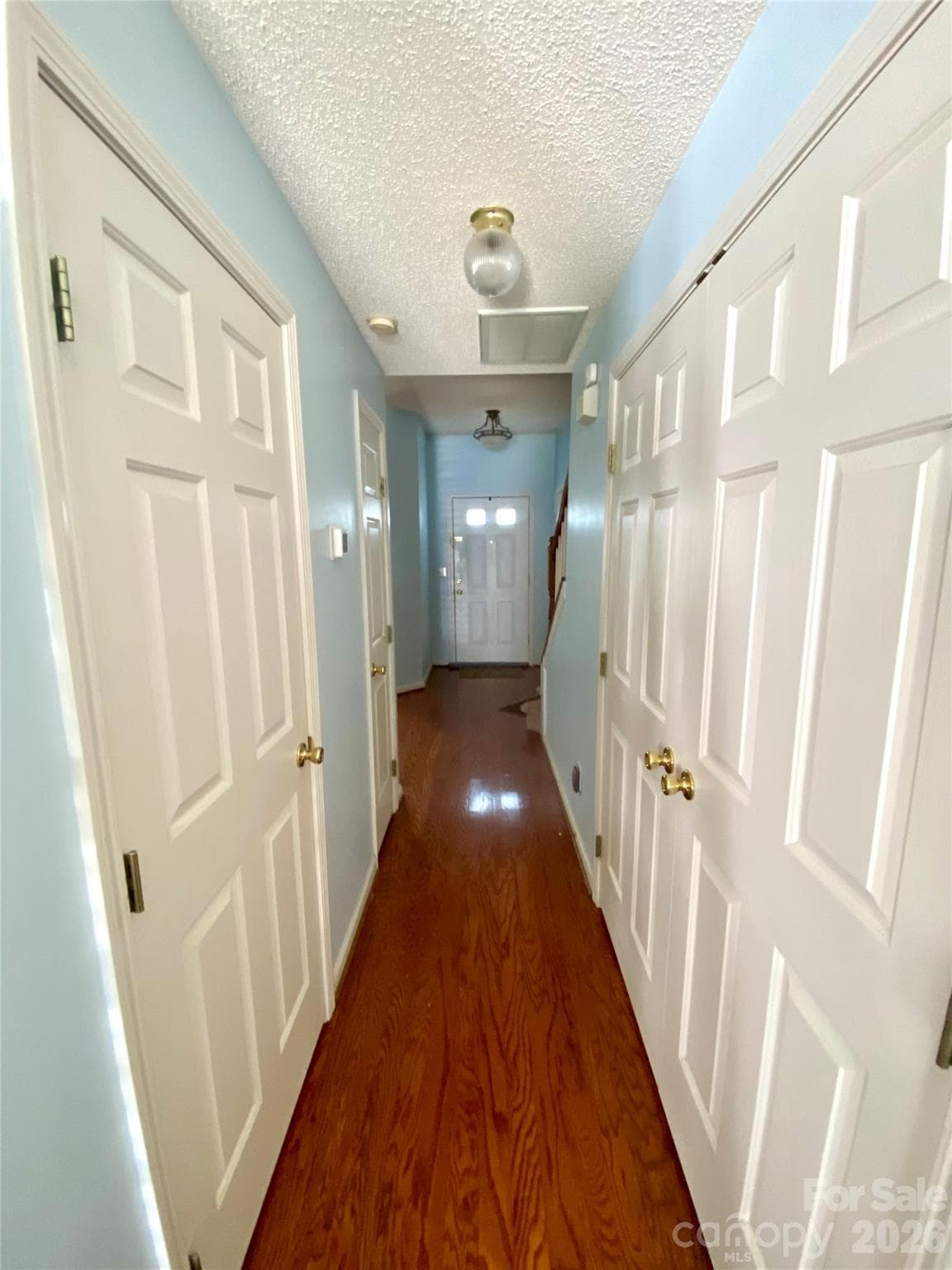 Hallway with Laundry closet on the right, 1/2 Bath on the left and linen closet also on the left. - 6025 Creft Circle, Indian Trail