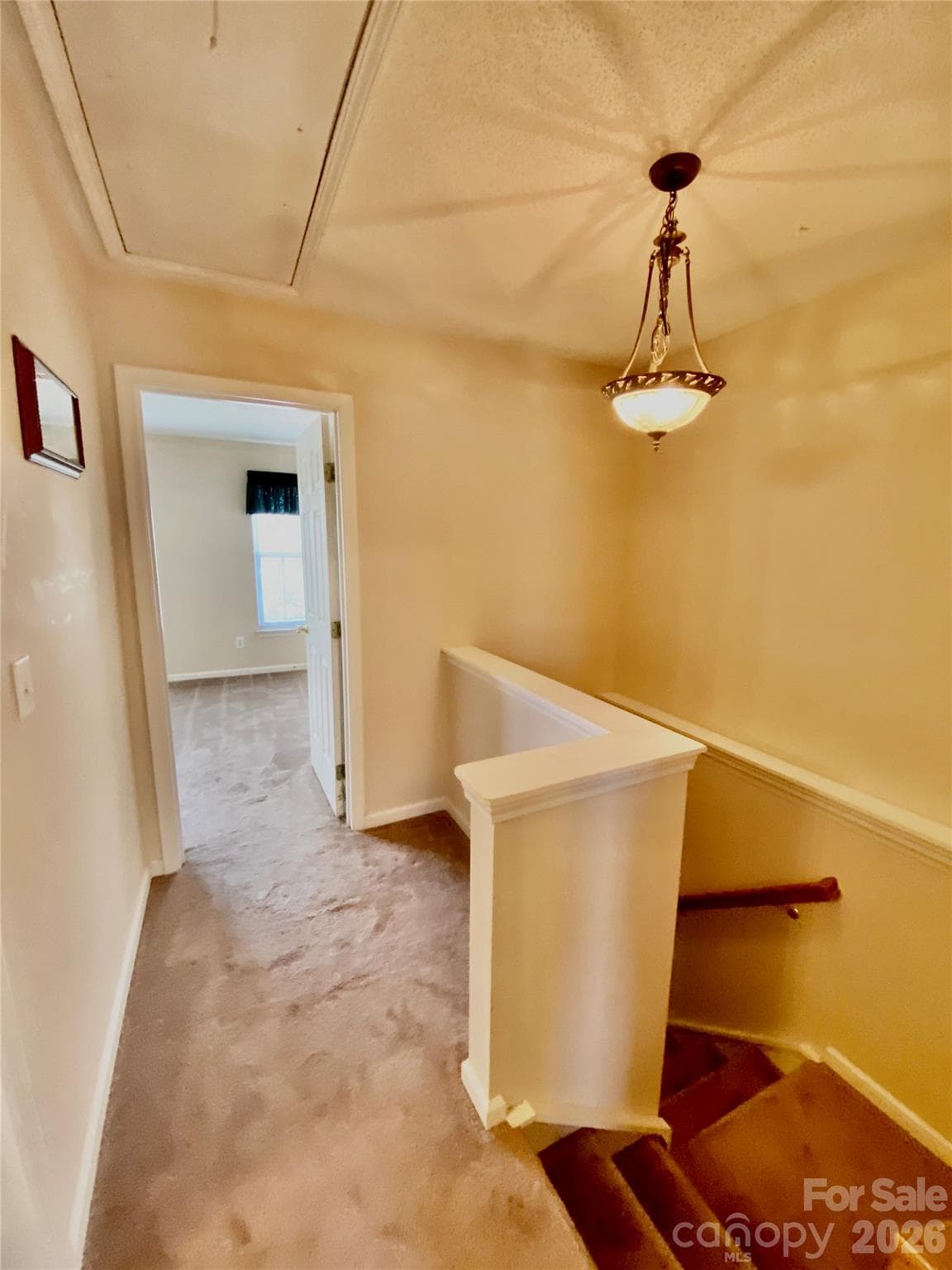 Upstairs Hallway niche area on the right, pull down attic stairs and door to the Secondary Bedroom. - 6025 Creft Circle, Indian Trail