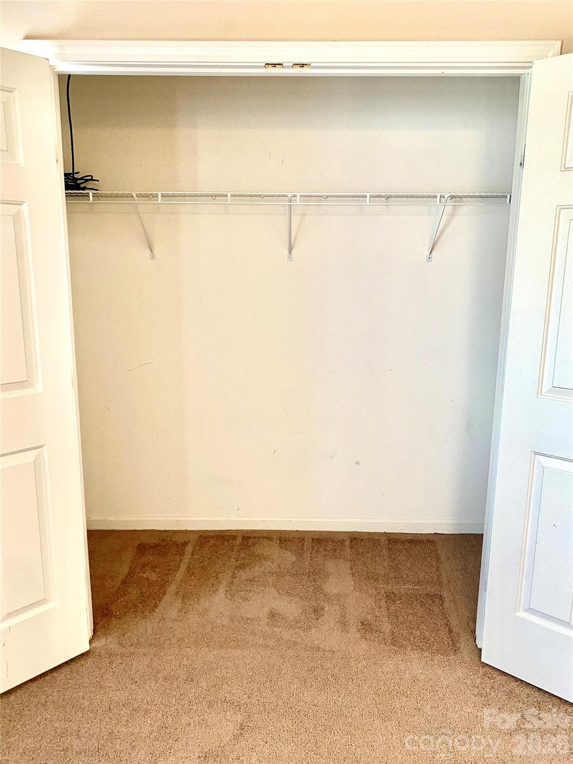 Secondary Bedroom spacious closet with shelves on the right. - 6025 Creft Circle, Indian Trail