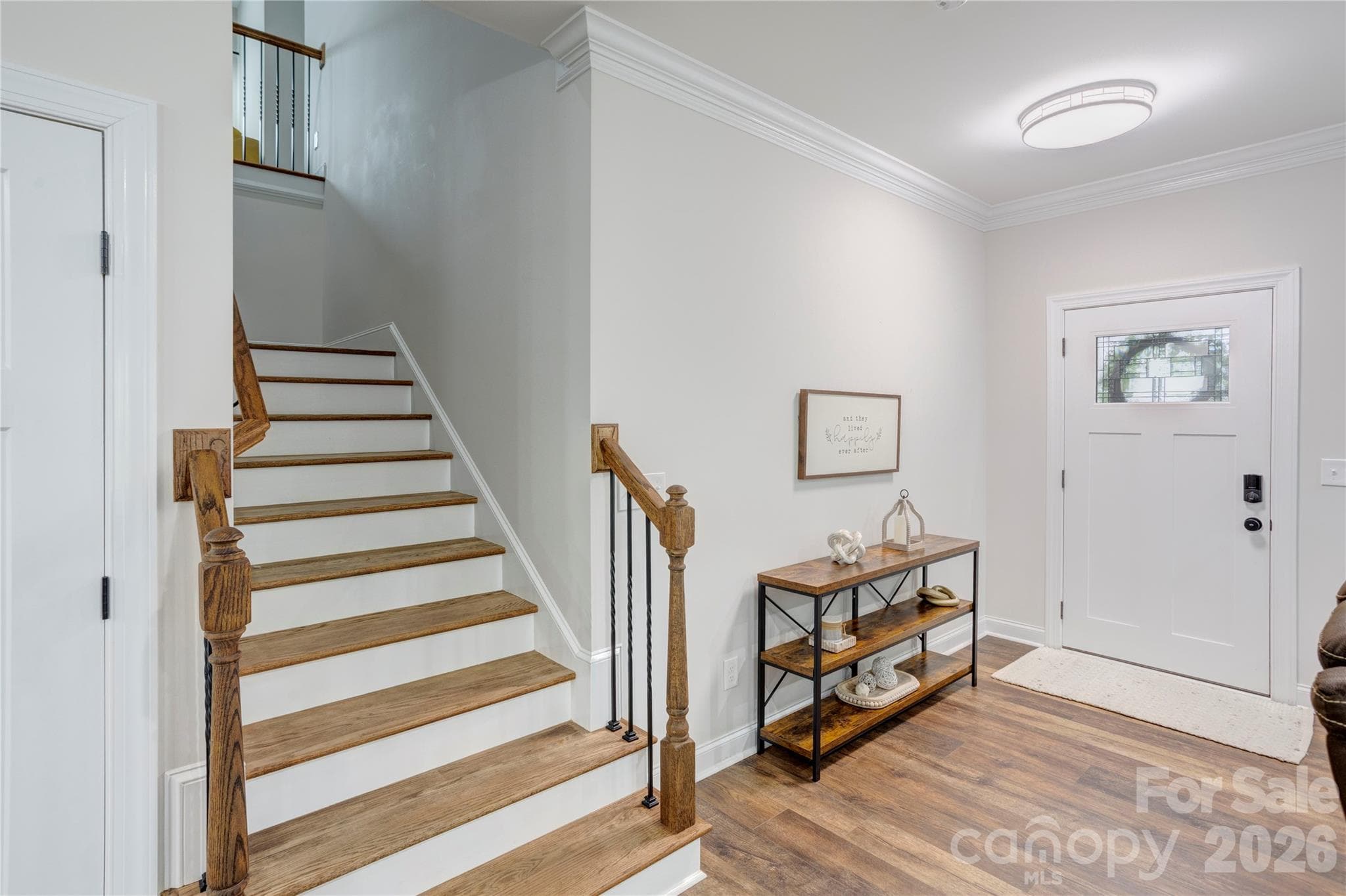 The wide real wood stairs lead to a large landing as you approach the loft/flex space upstairs. - 317 Oak Brook Drive, Salisbury