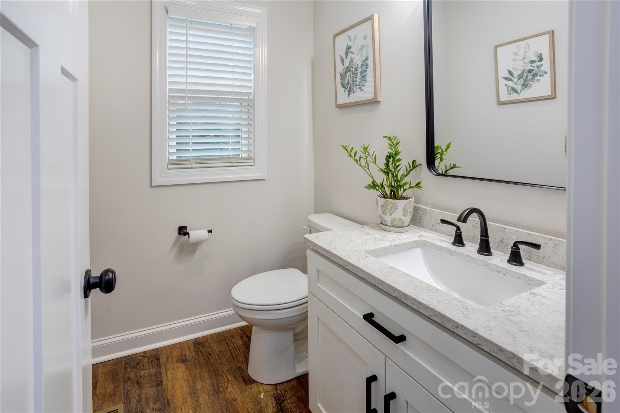 Downstairs half bath inside the garage hallway. - 317 Oak Brook Drive, Salisbury