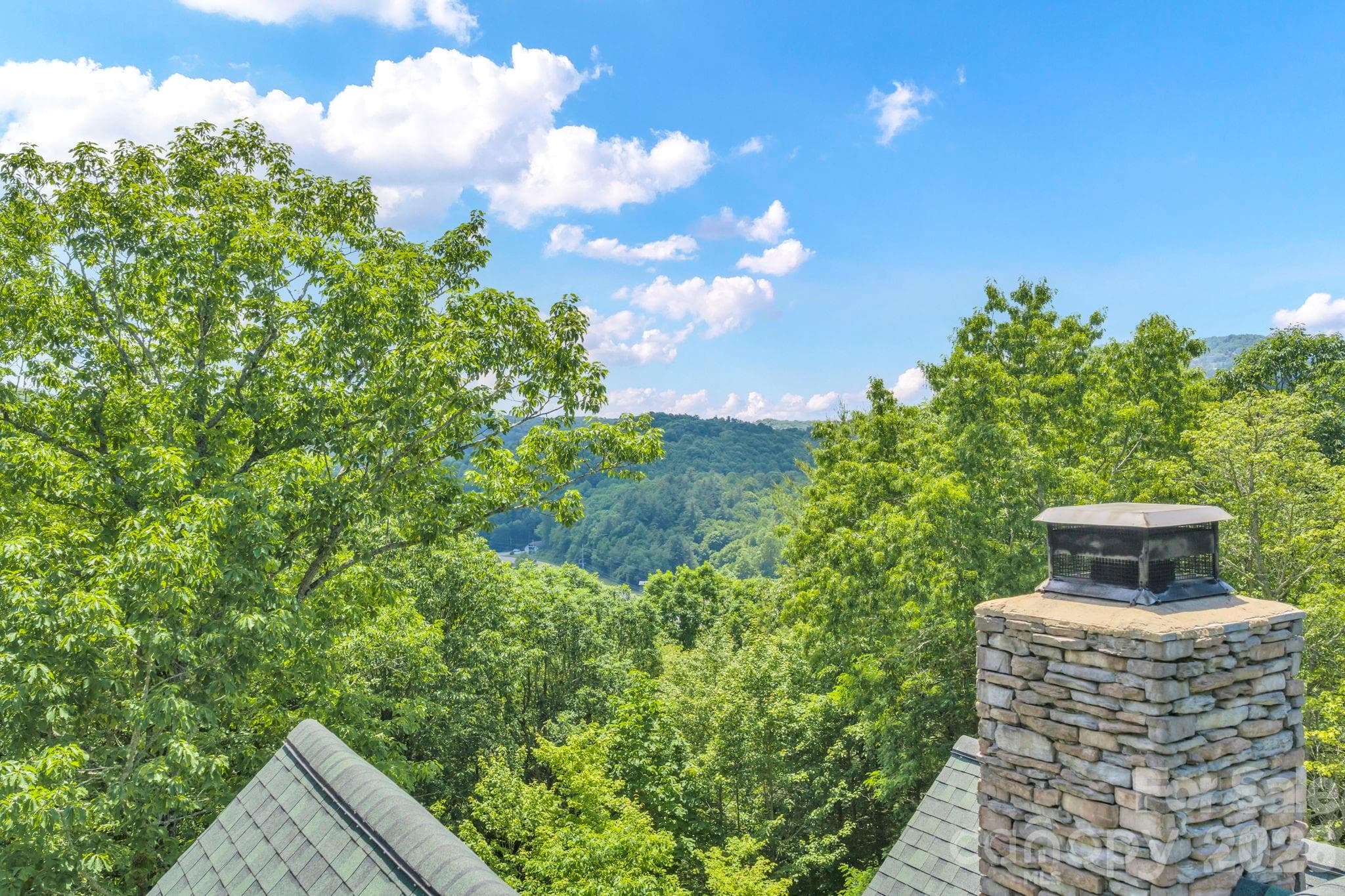 Soft mountain view! Photo taken just above roof. - 328 Nile Park Drive, Blowing Rock