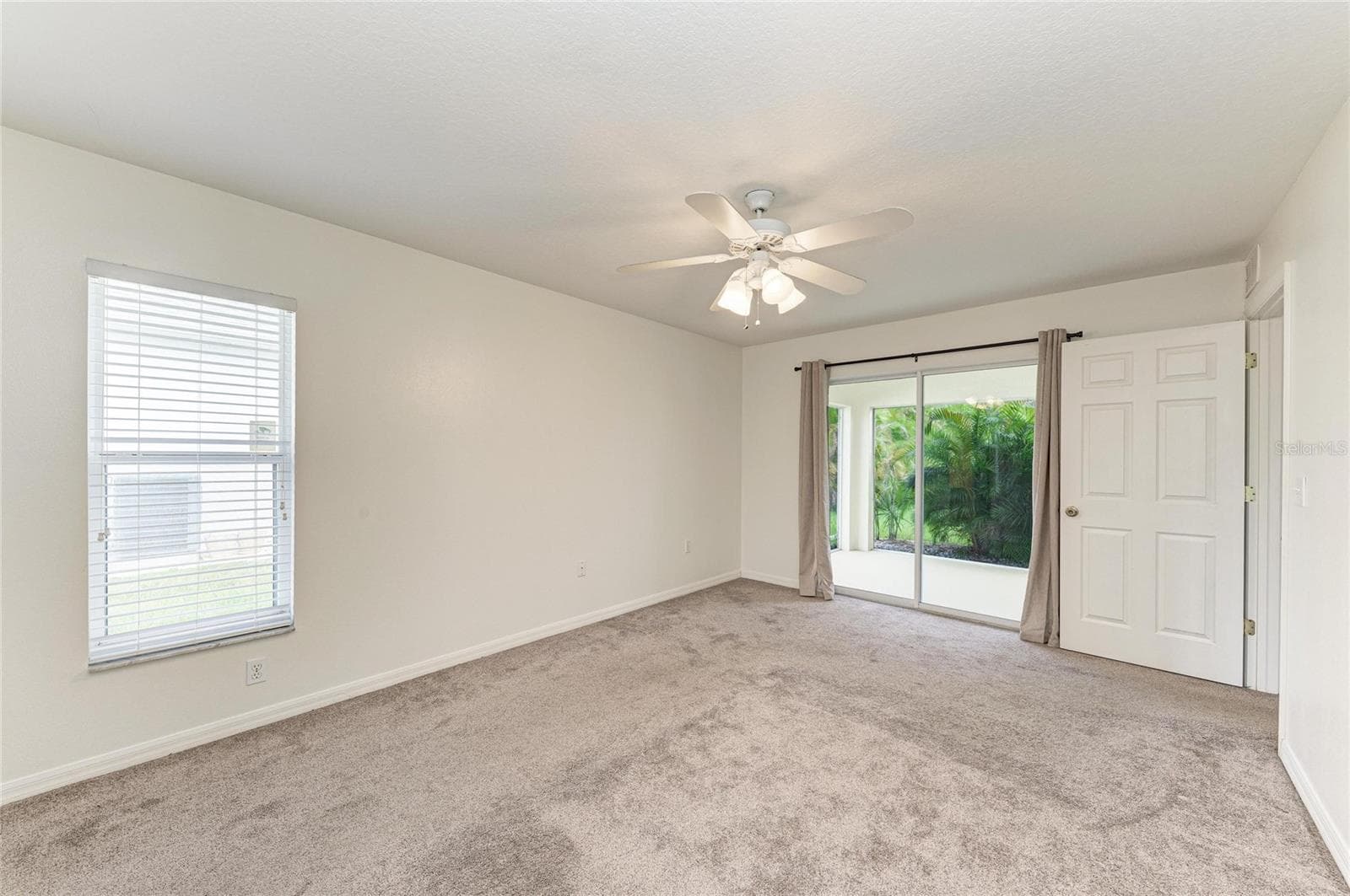 Primary Bedroom with sliding glass doors to screened lanai - 3213 45TH AVE E, BRADENTON