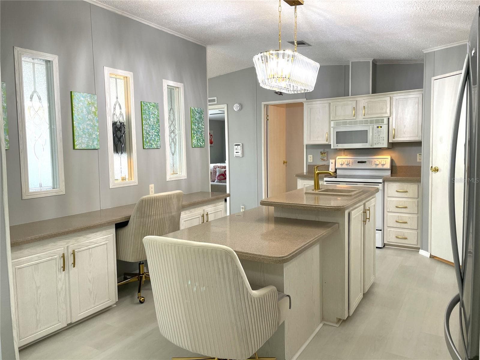 Windows in center wall allow natural light into the Kitchen - 24437 HARBORVIEW RD #70, PORT CHARLOTTE