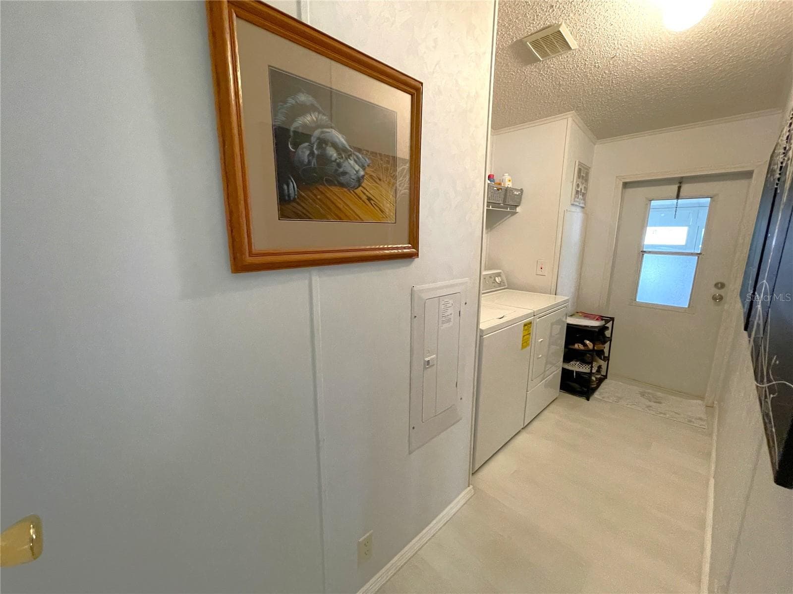 Spacious Laundry room leads to lanai and carport - 24437 HARBORVIEW RD #70, PORT CHARLOTTE