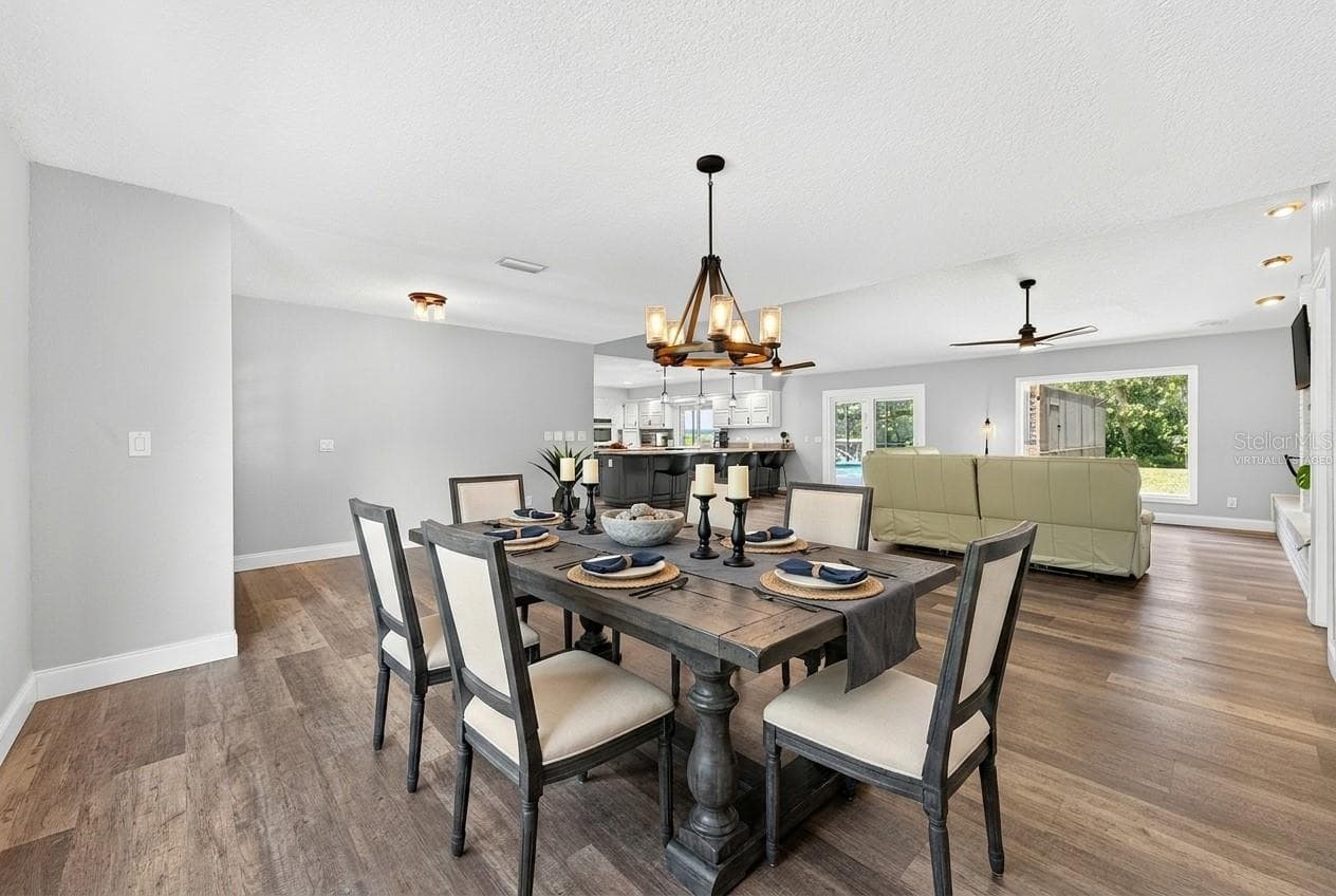 Open concept main living has a seamless flow from the dining area into the living area and the kitchen beyond. Virtually Staged. - 1600 E 10TH ST, ST CLOUD