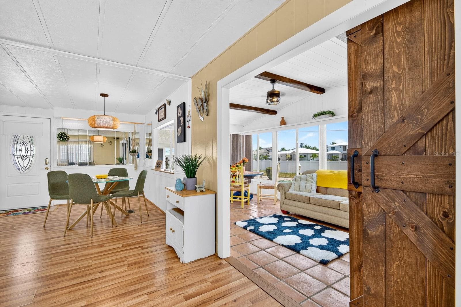 Sleek barn door showcasing the front lanai that is under a/c in the front and open to home - 2107 PALMA SOLA BLVD #17, BRADENTON