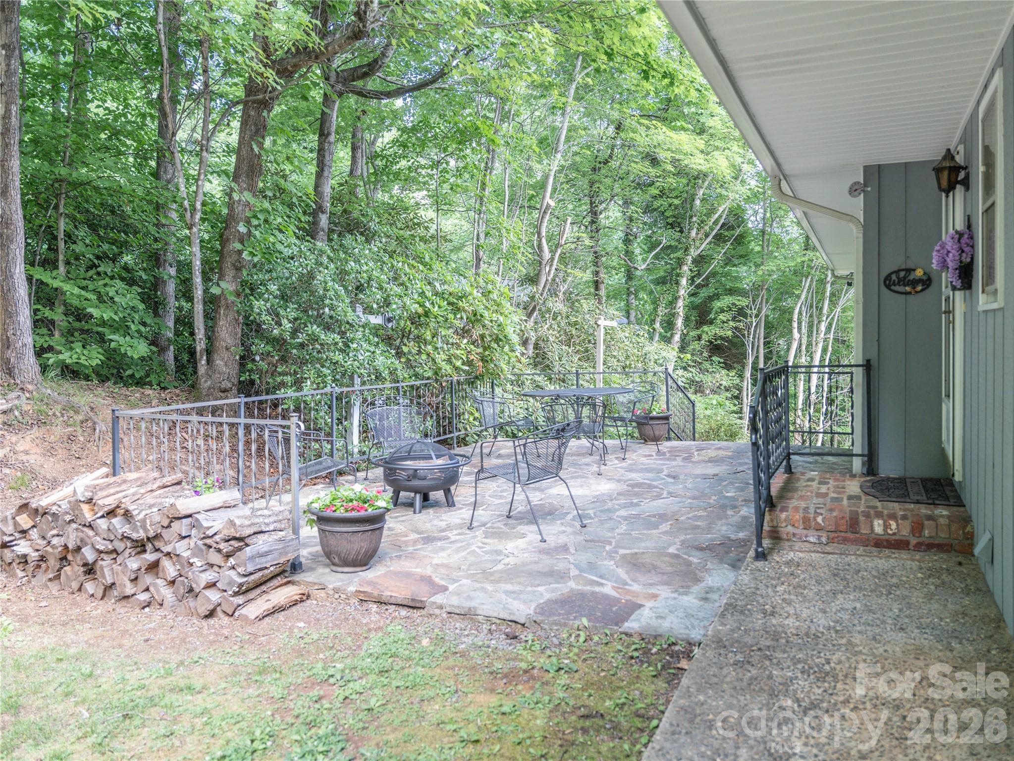 Large patio with firepit and furniture that stays with the home. - Black Mountain
