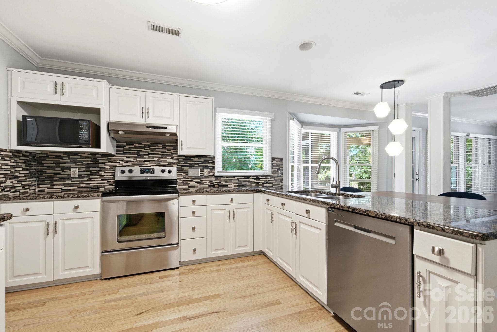 Beautiful glass tile backsplash, granite countertops, plenty of storage, dishwasher replaced in 2024 and floors refinished in 2024 - 503 Wyre Forest Court, Charlotte