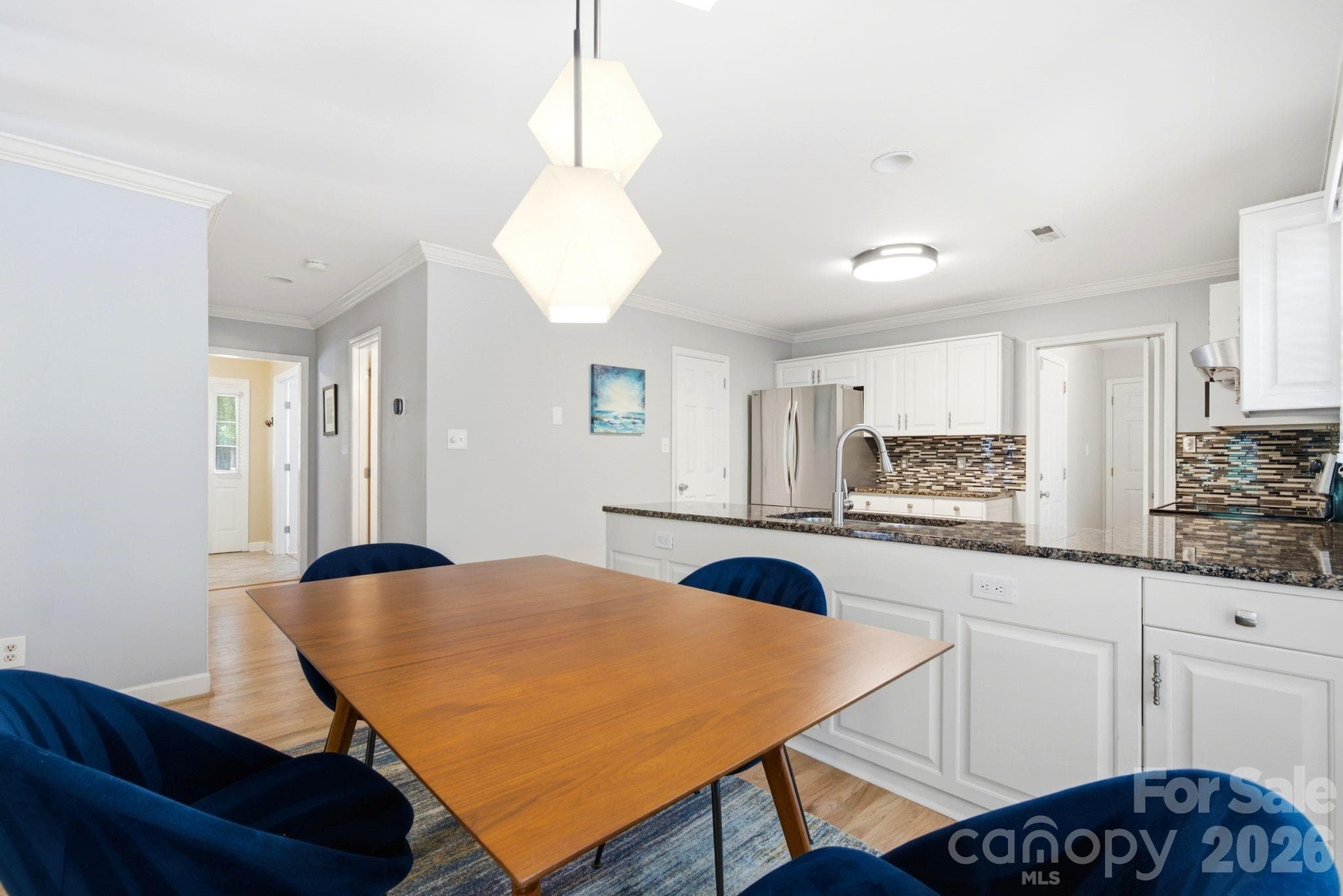 Open-concept kitchen and dining area featuring modern finishes, ample natural light, and space for hosting. - 503 Wyre Forest Court, Charlotte