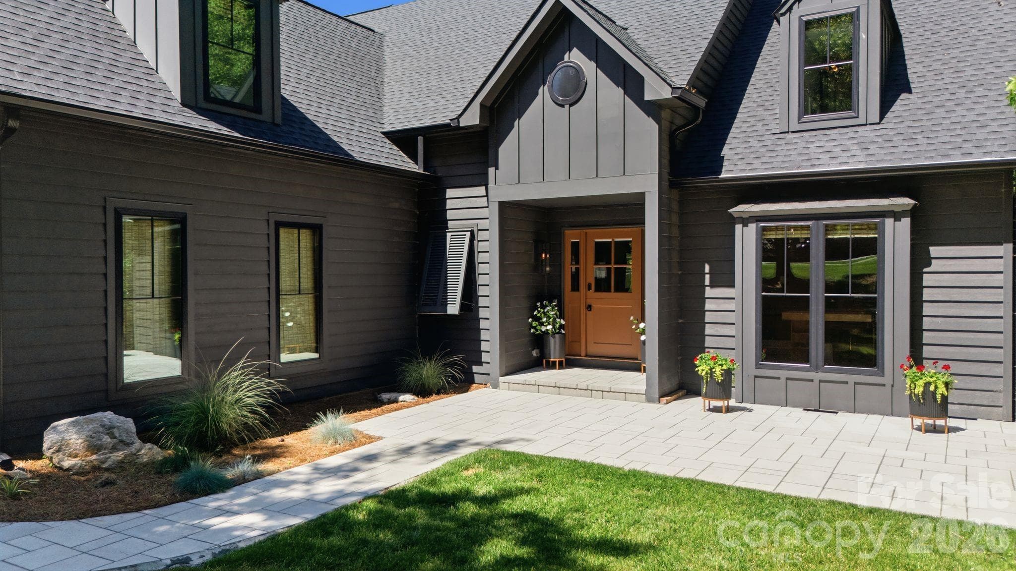 Welcoming front entry with charming architectural detail and a classic Dutch-style door. This image highlights the thoughtful design details buyers notice before they ever step inside. - Cornelius
