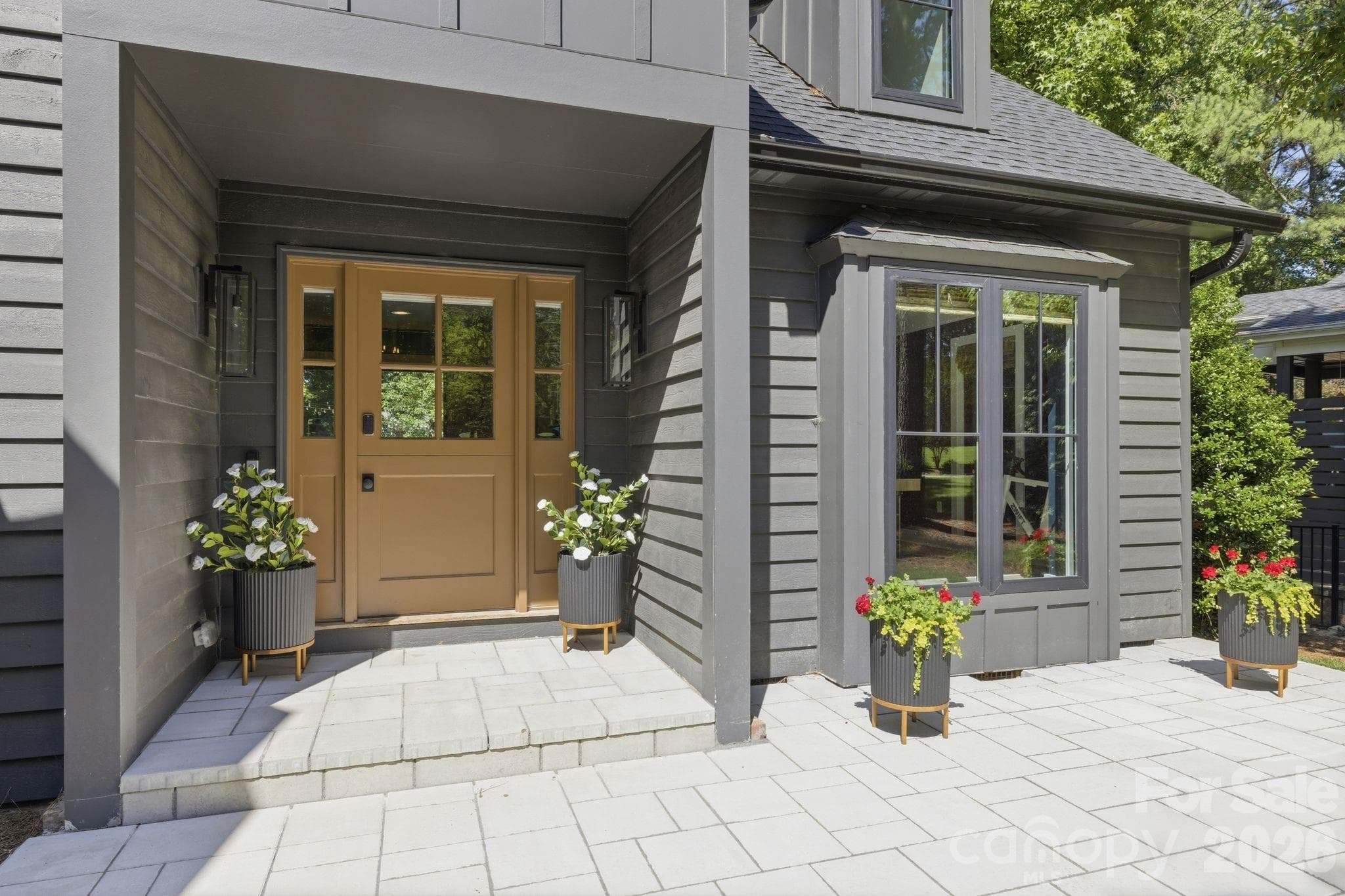 Close-up of the distinctive front door and entry details, adding warmth and character to the home’s first impression. A great detail shot to reinforce the custom, curated feel. - Cornelius