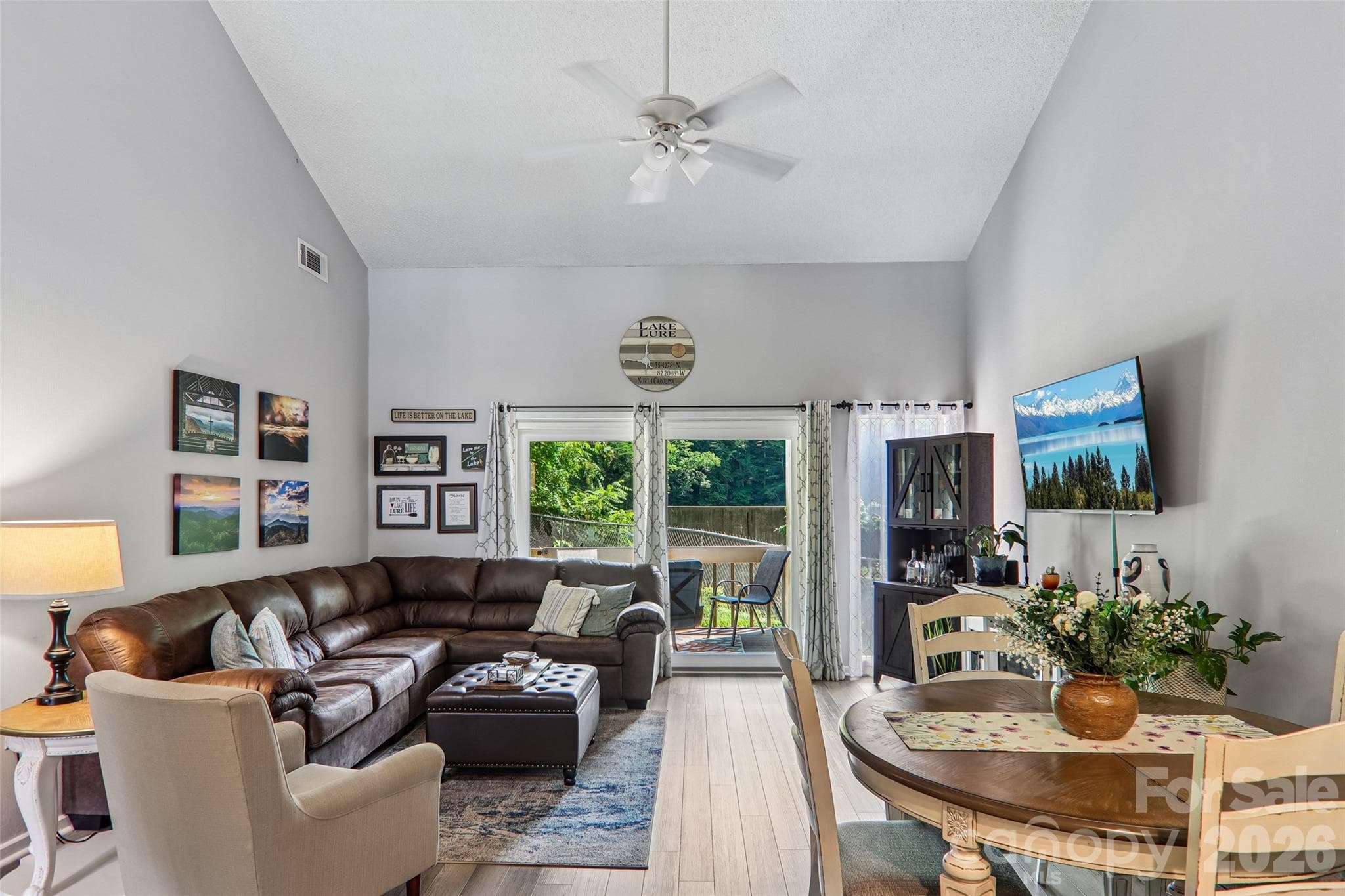 living room opens onto deck overlooking lake - 147 W Lake Drive S, Lake Lure