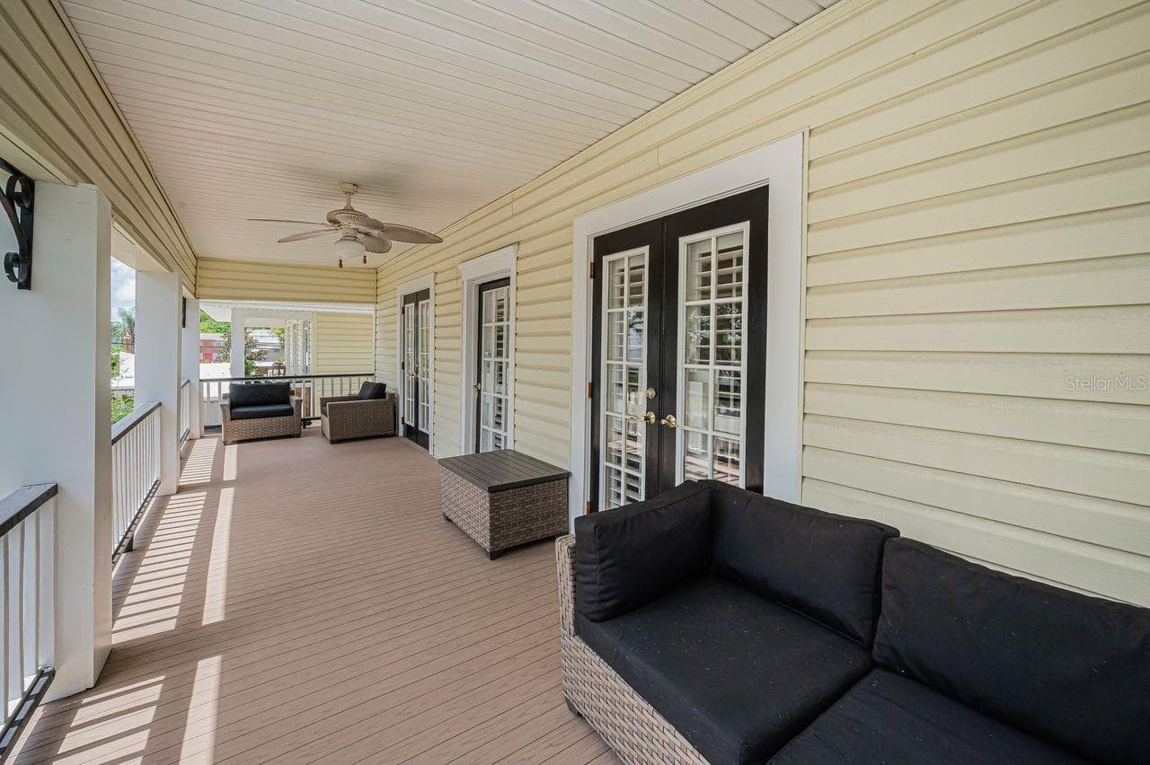 A main home balcony, open, and full of quiet charm. - 732 NE OAK ST, ST PETERSBURG
