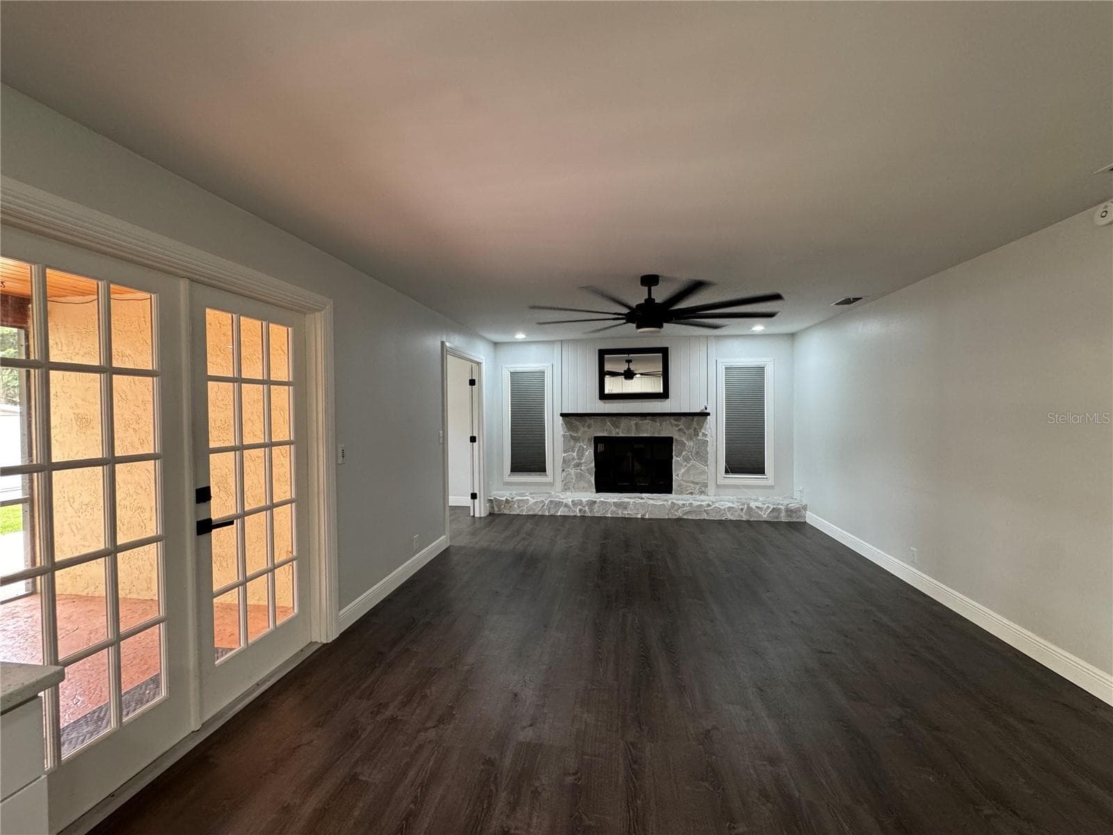 This image features a large, spacious family room designed for comfort and entertainment, offering an open floor plan that flows seamlessly into the rest of the home. - 1809 STELLA CT N, LAKELAND