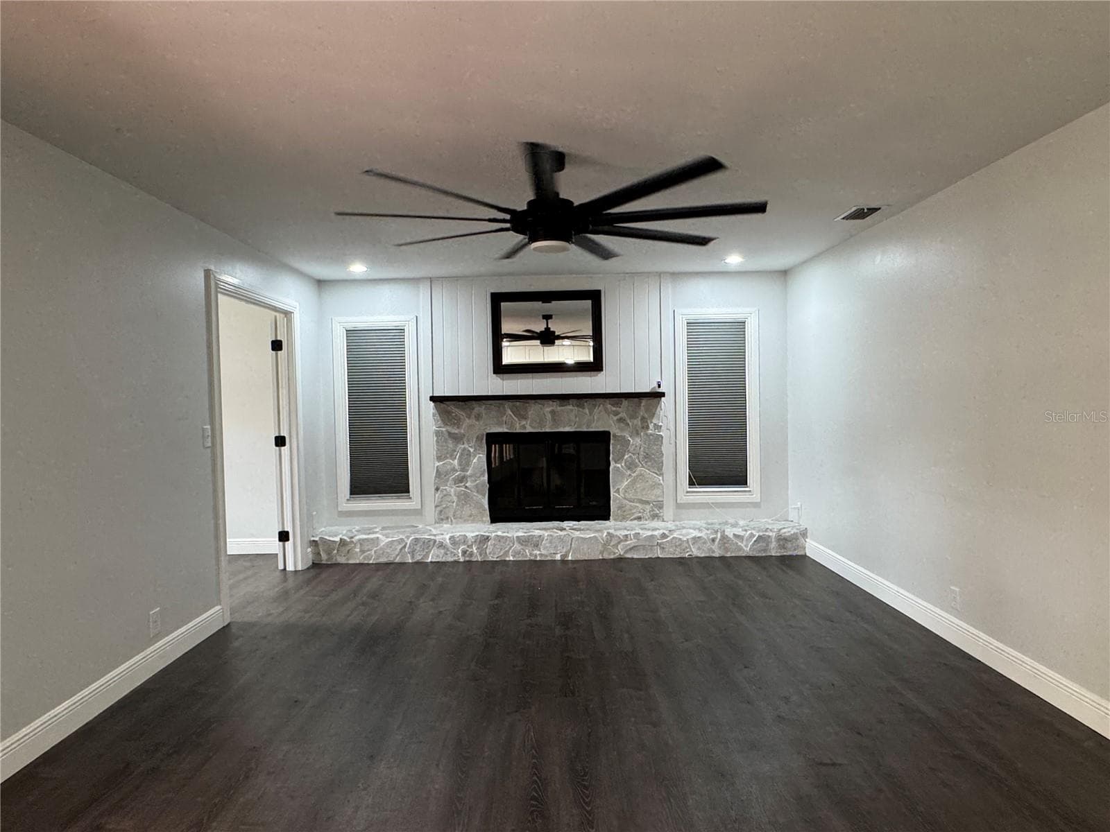 This image features a large, spacious family room designed for comfort and entertainment, offering an open floor plan that flows seamlessly into the rest of the home. - 1809 STELLA CT N, LAKELAND