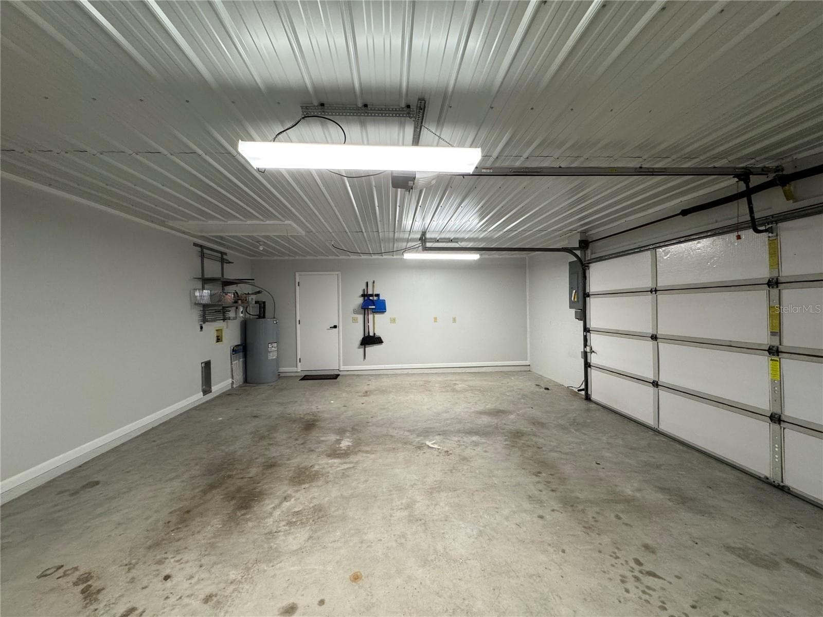 This photo features the property's oversized garage, which provides ample space for storage and larger vehicles. - 1809 STELLA CT N, LAKELAND