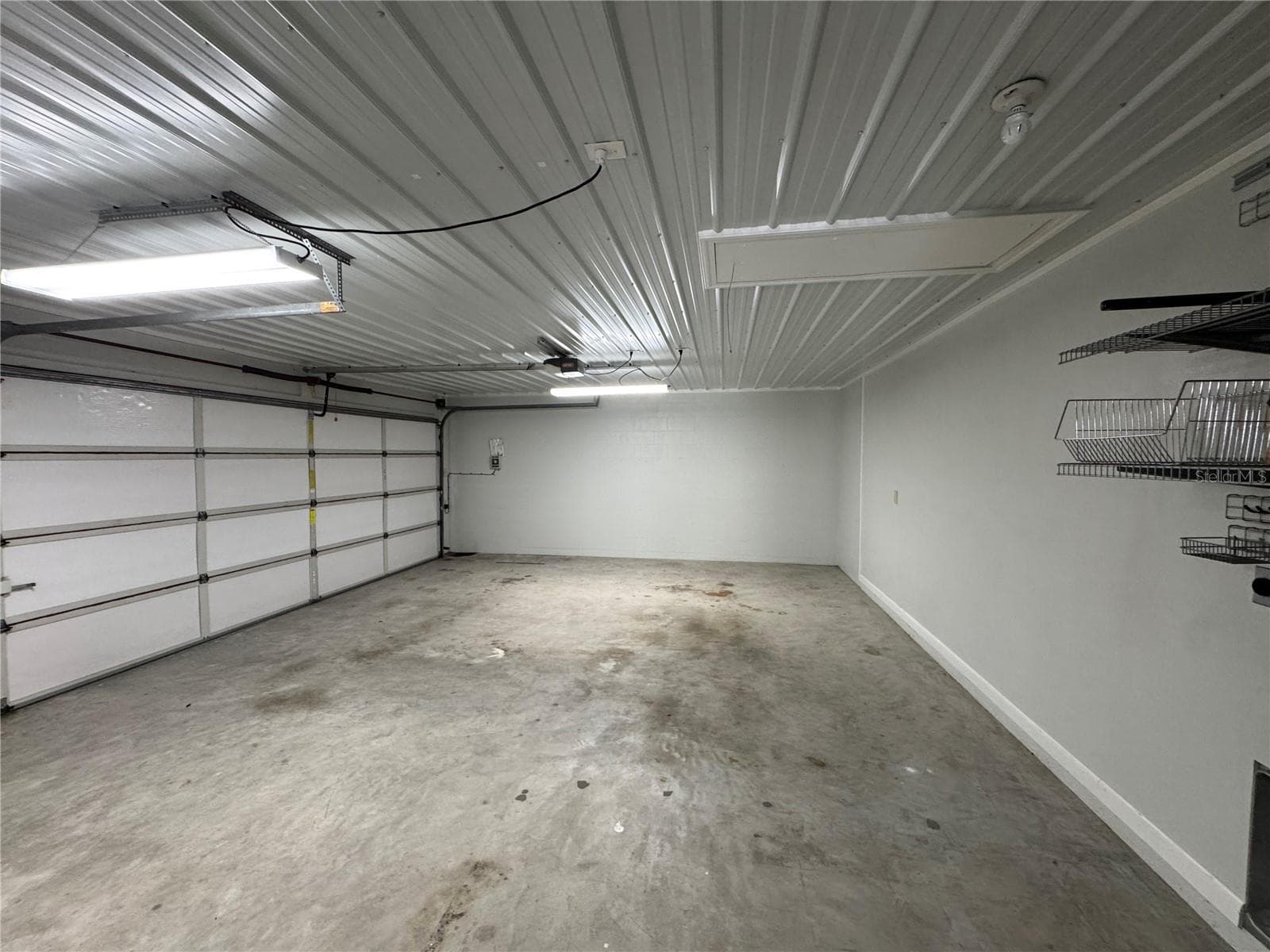 This photo features the property's oversized garage, which provides ample space for storage and larger vehicles. - 1809 STELLA CT N, LAKELAND
