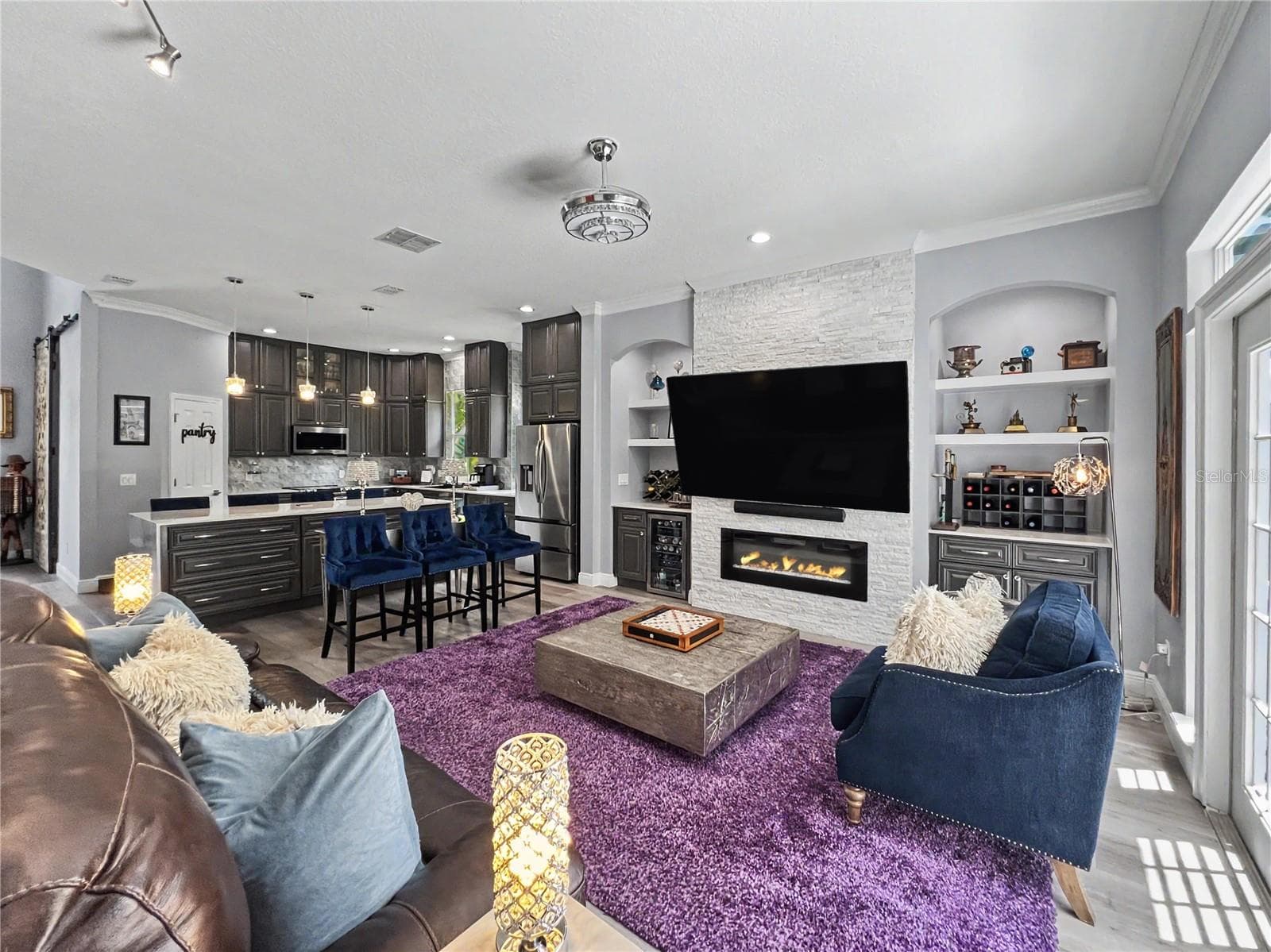 Fun family room off of screened in pool with massive television - 816 RUNNER OAK ST, CELEBRATION