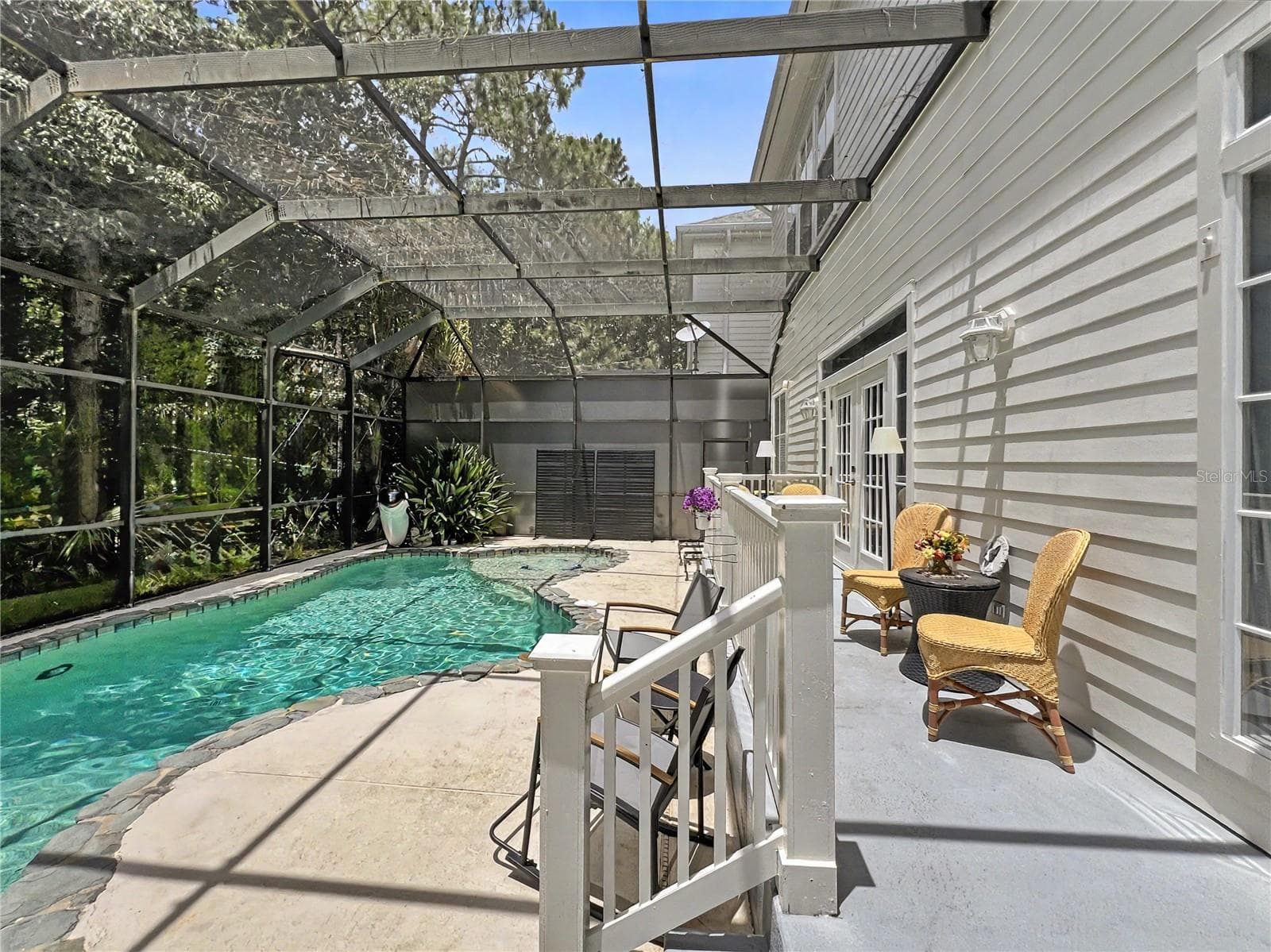 back porch with doors to first floor primary - 816 RUNNER OAK ST, CELEBRATION