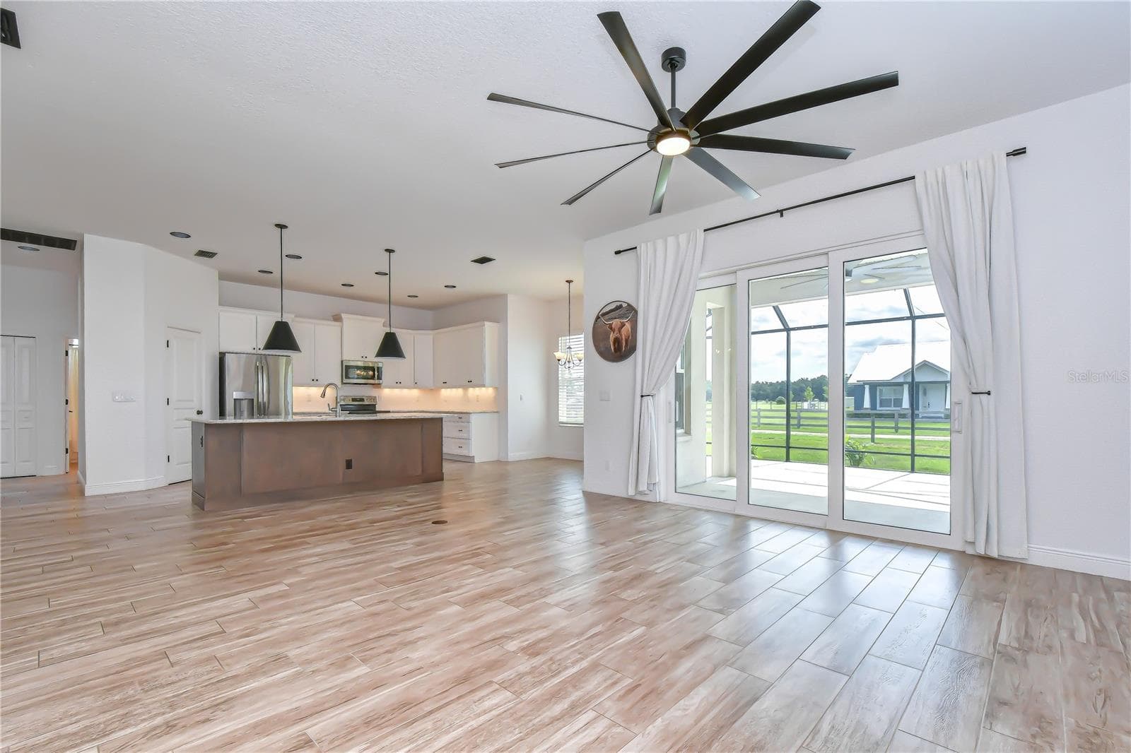 Expansive gathering space with picturesque backyard views. - 4008 MCINTOSH ESTATES LN, PLANT CITY