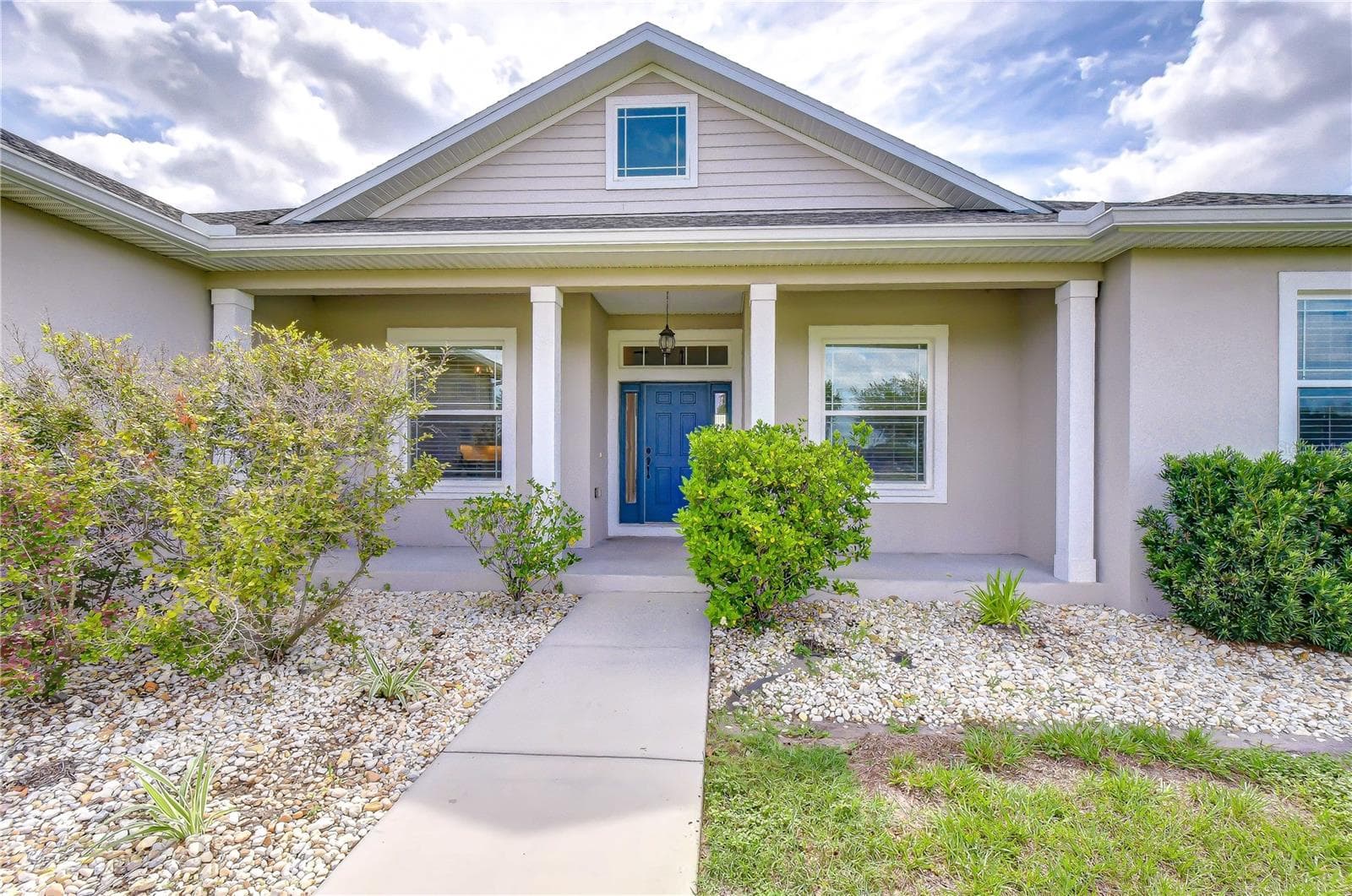 Inviting covered porch perfect for rocking chairs and enjoying peaceful country views. - 4008 MCINTOSH ESTATES LN, PLANT CITY