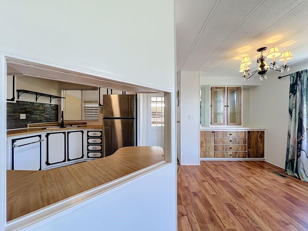 Kitchen pass through and dining area - 1203 APACHE CIR, TAVARES