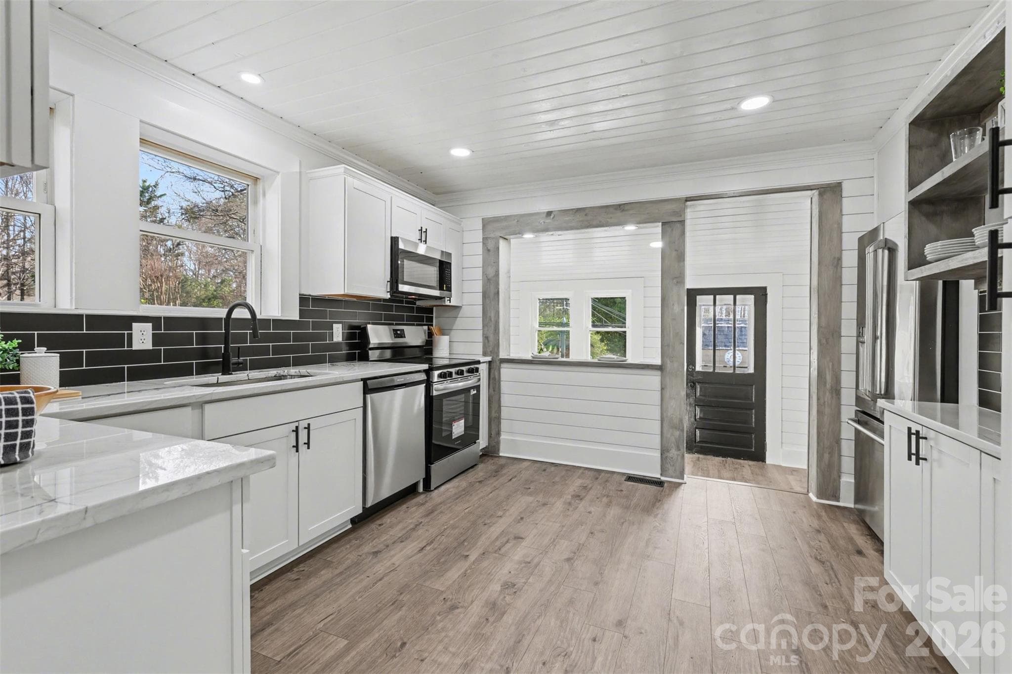 Kitchen has enough space to add a butcher block island. Pantry and wine/barista or serving bar to the right, so versatile. The bar to the right of the range is lower on the other side to add bar stools too! - 622 Neelys Creek Road, Rock Hill