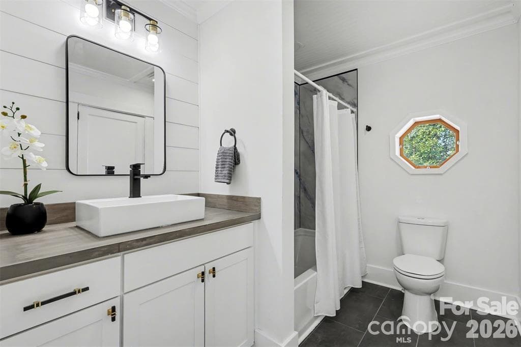 Hall bath with marble surround in the shower/tub, new countertop, fixtures, and tiled flooring..nothing left overlooked - 622 Neelys Creek Road, Rock Hill