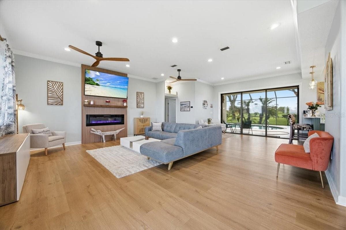 Spacious Living Room with 2 Ceiling Fans. Recessed Lighting & Electric Fireplace - 915 N CROOKED LAKE DR, BABSON PARK