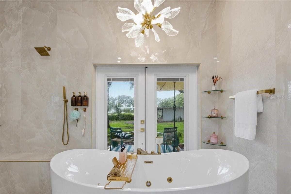 Soak in your multi-jetted jacuzzi while enjoying the serene outdoor views - 915 N CROOKED LAKE DR, BABSON PARK