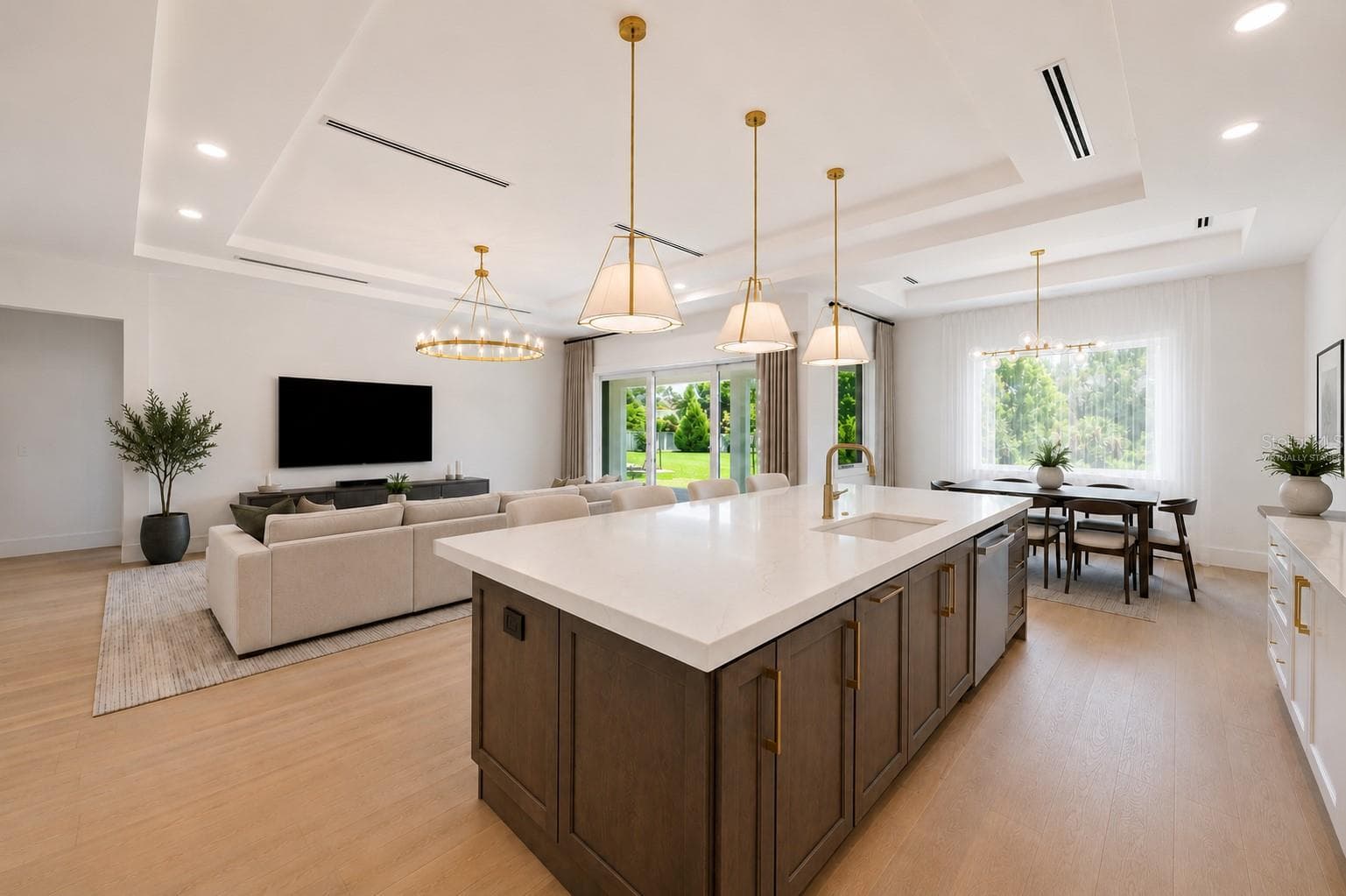 Virtually staged.The gourmet kitchen is a true showpiece, featuring full-height custom cabinetry, an oversized 11-foot quartz island with storage on both sides, marble backsplash, GE Profile appliances, custom range hood, cooktop, wall oven, and soft-close cabinetry throughout. - 1336 HAYS RD, TARPON SPRINGS