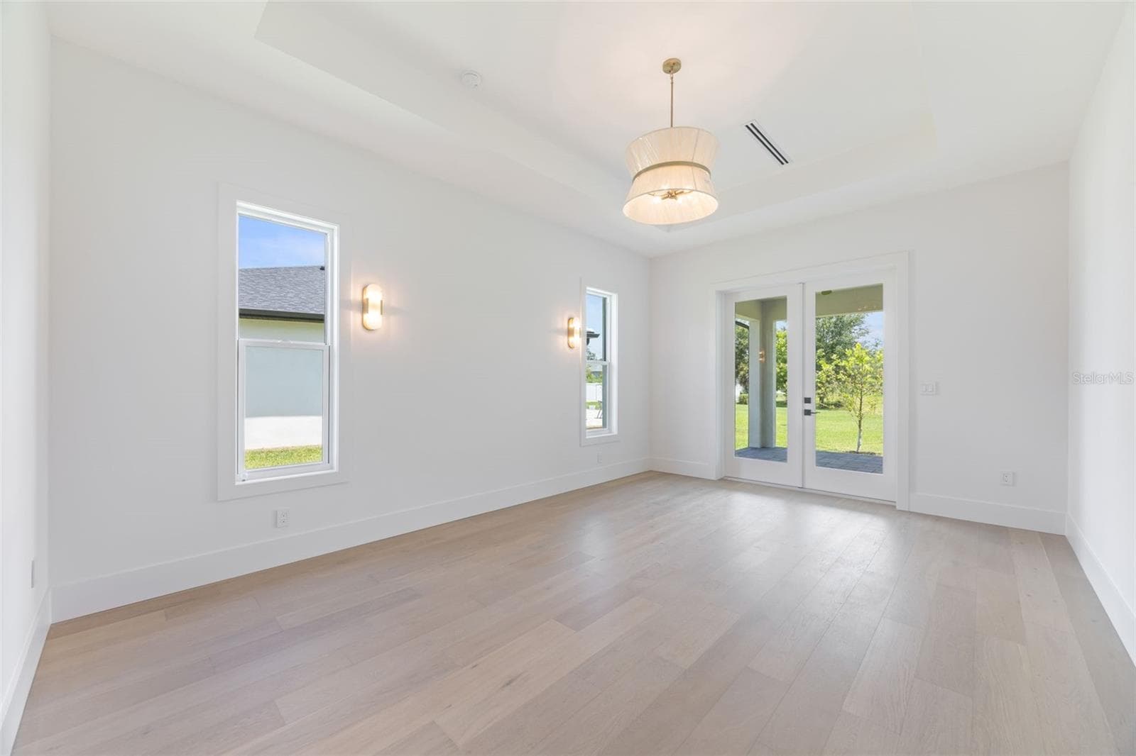 The luxurious primary suite offers a spa-inspired retreat featuring a freestanding soaking tub, oversized walk-in shower with rain head and handheld shower, premium Italian tile, designer fixtures, and thoughtful custom details throughout. - 1336 HAYS RD, TARPON SPRINGS