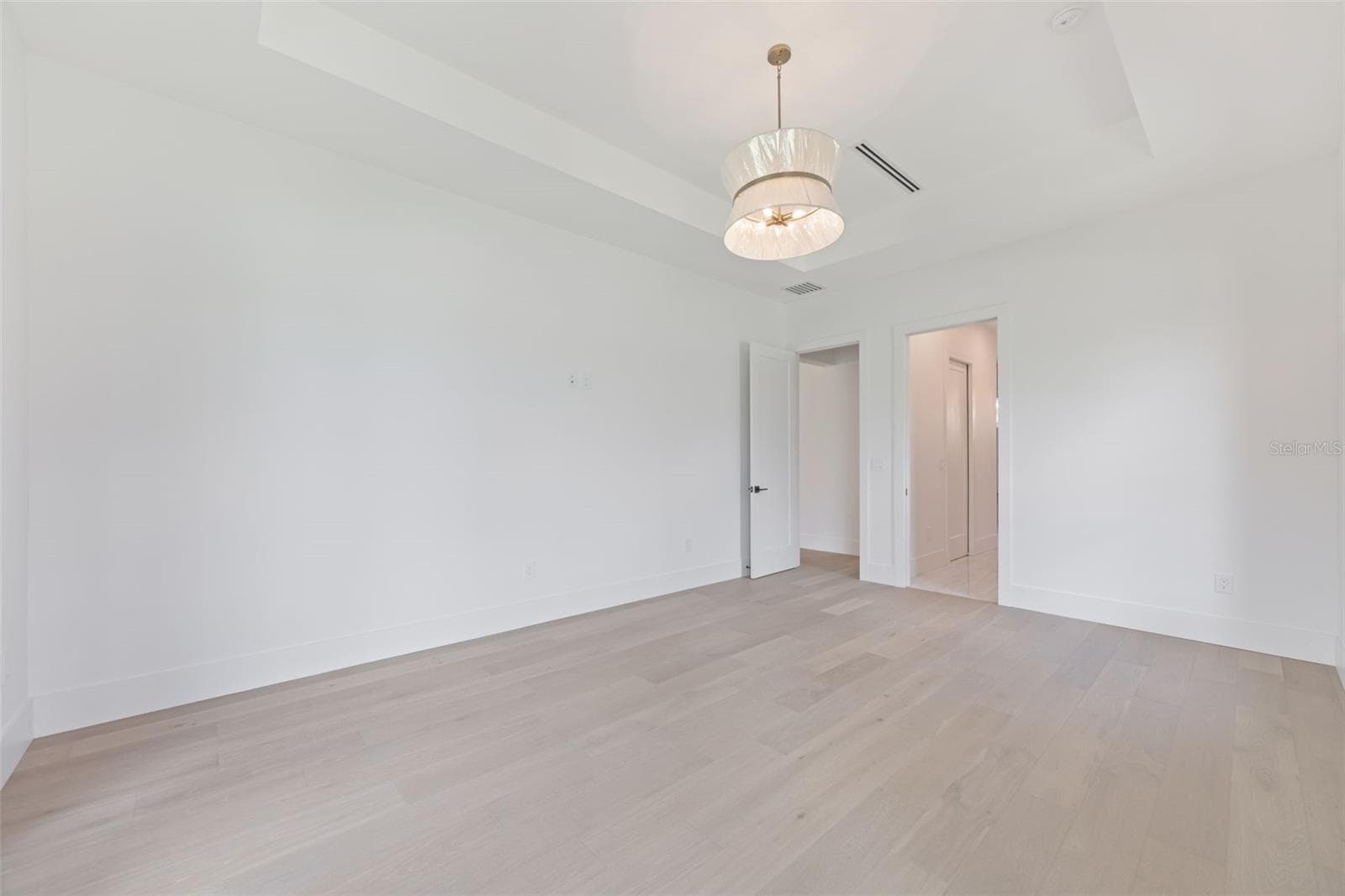 The luxurious primary suite offers a spa-inspired retreat featuring a freestanding soaking tub, oversized walk-in shower with rain head and handheld shower, premium Italian tile, designer fixtures, and thoughtful custom details throughout. - 1336 HAYS RD, TARPON SPRINGS