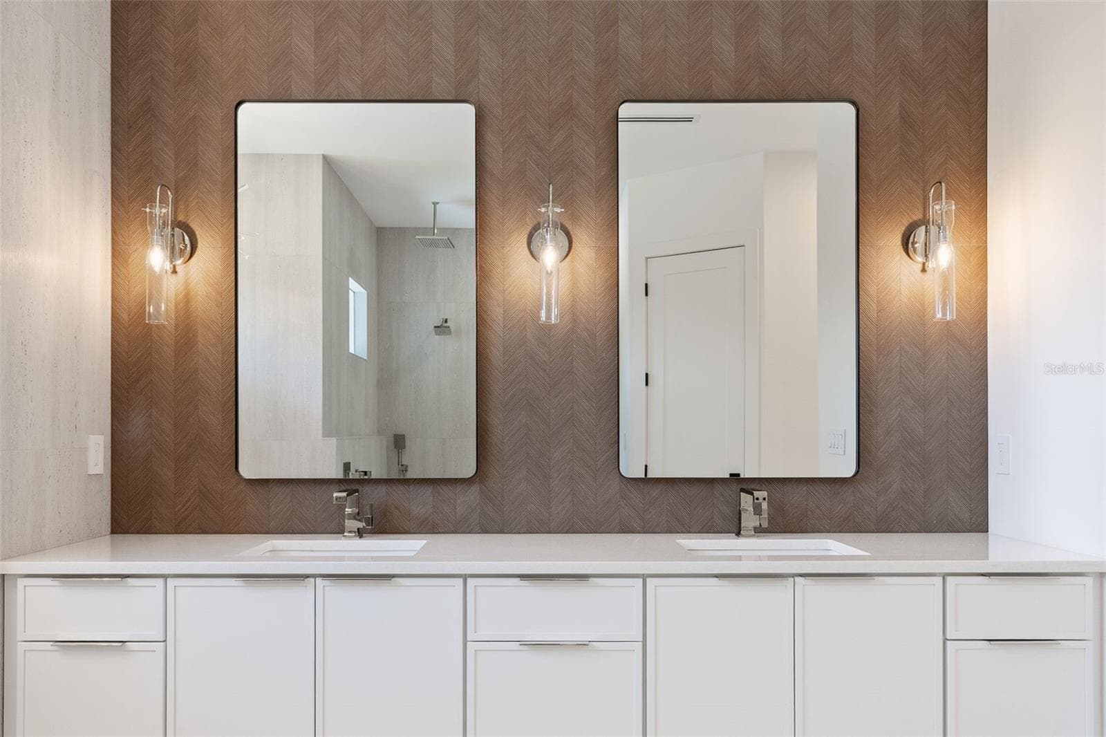 The luxurious primary suite offers a spa-inspired retreat featuring a freestanding soaking tub, oversized walk-in shower with rain head and handheld shower, premium Italian tile, designer fixtures, and thoughtful custom details throughout. - 1336 HAYS RD, TARPON SPRINGS