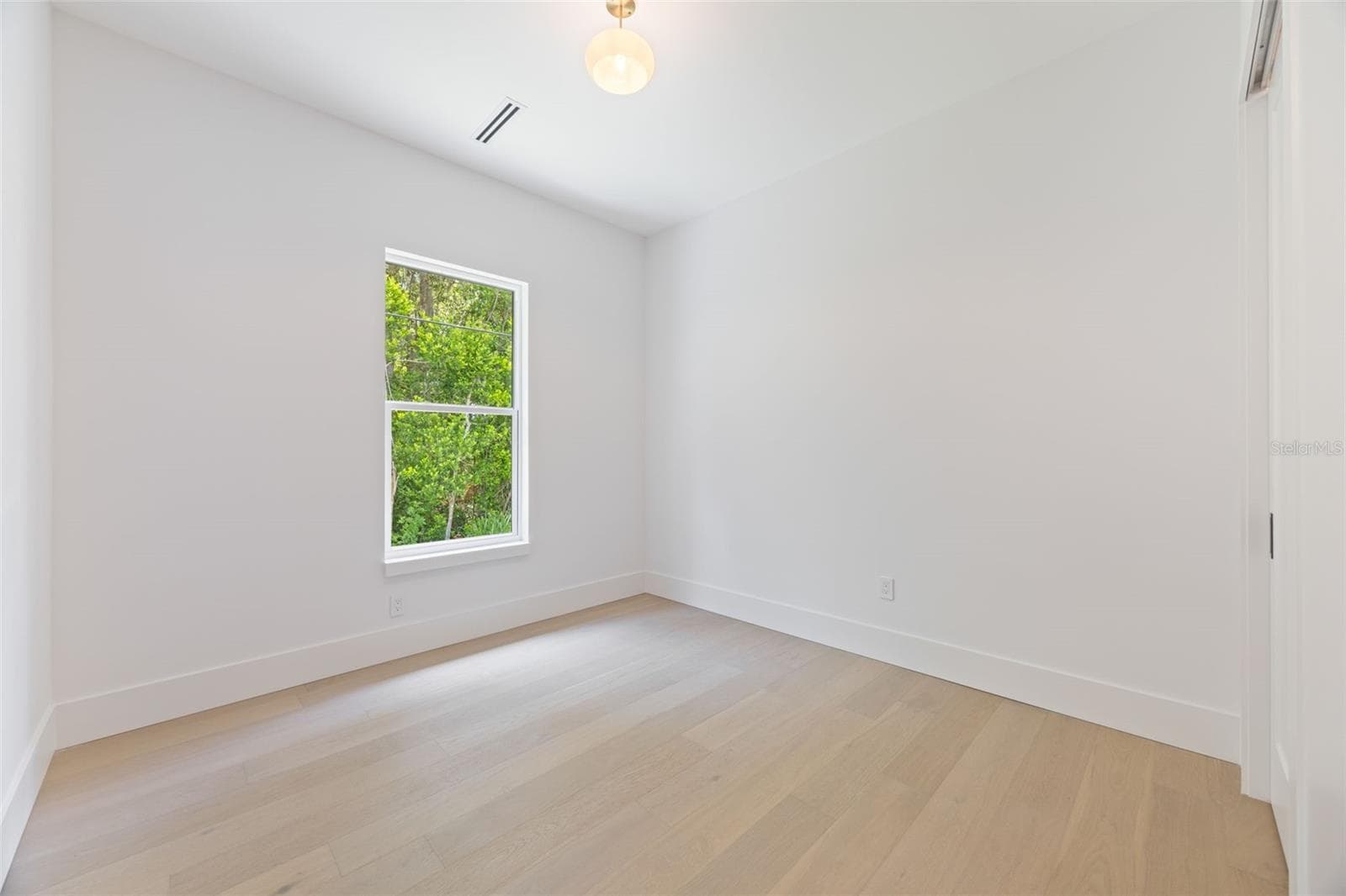 Bedroom 2 is generously sized and conveniently located near a full guest bathroom. - 1336 HAYS RD, TARPON SPRINGS