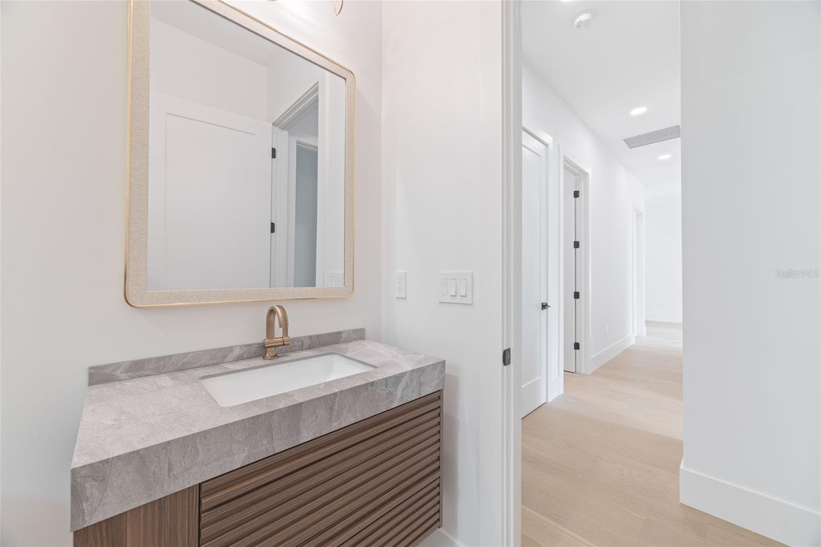 The 2nd full bathroom showcases oversized Italian tile, designer-selected fixtures, and elegant finishes consistent with the home's custom craftsmanship. - 1336 HAYS RD, TARPON SPRINGS