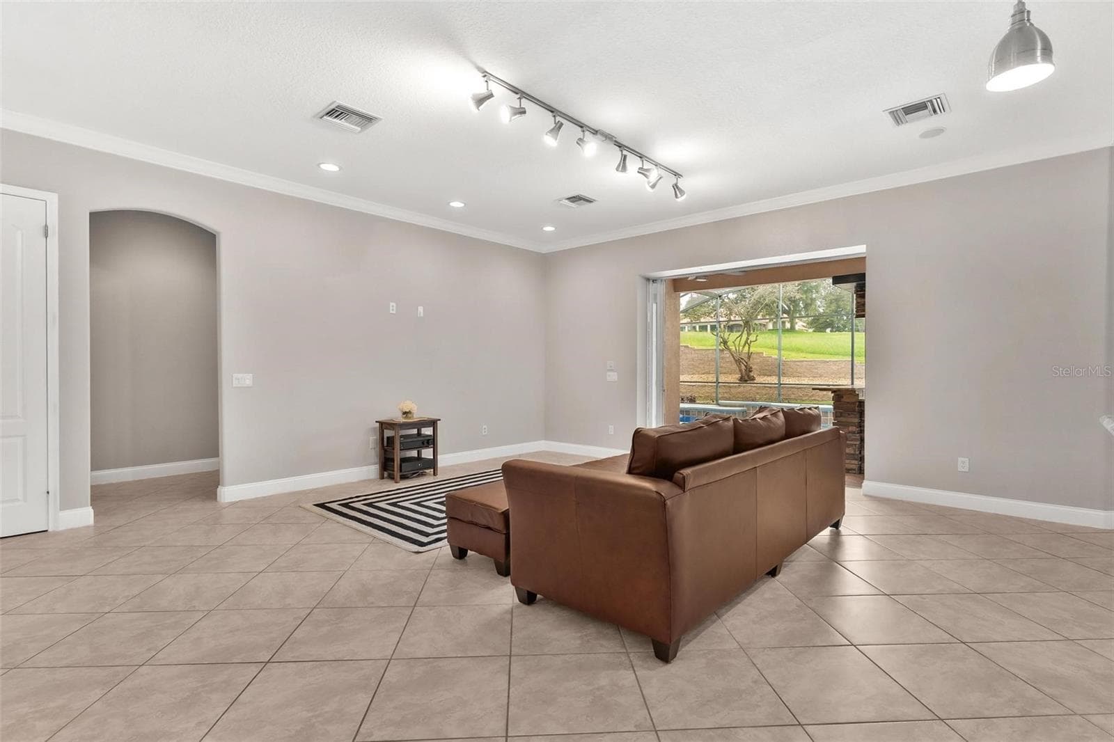 Living Area with Sliders to the Pool Area - 5506 CITATION CT, LADY LAKE