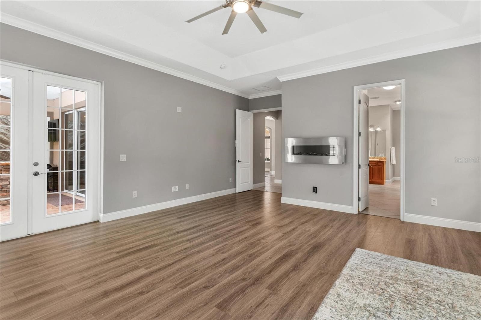 Primary Bedroom with electric fireplace - 5506 CITATION CT, LADY LAKE