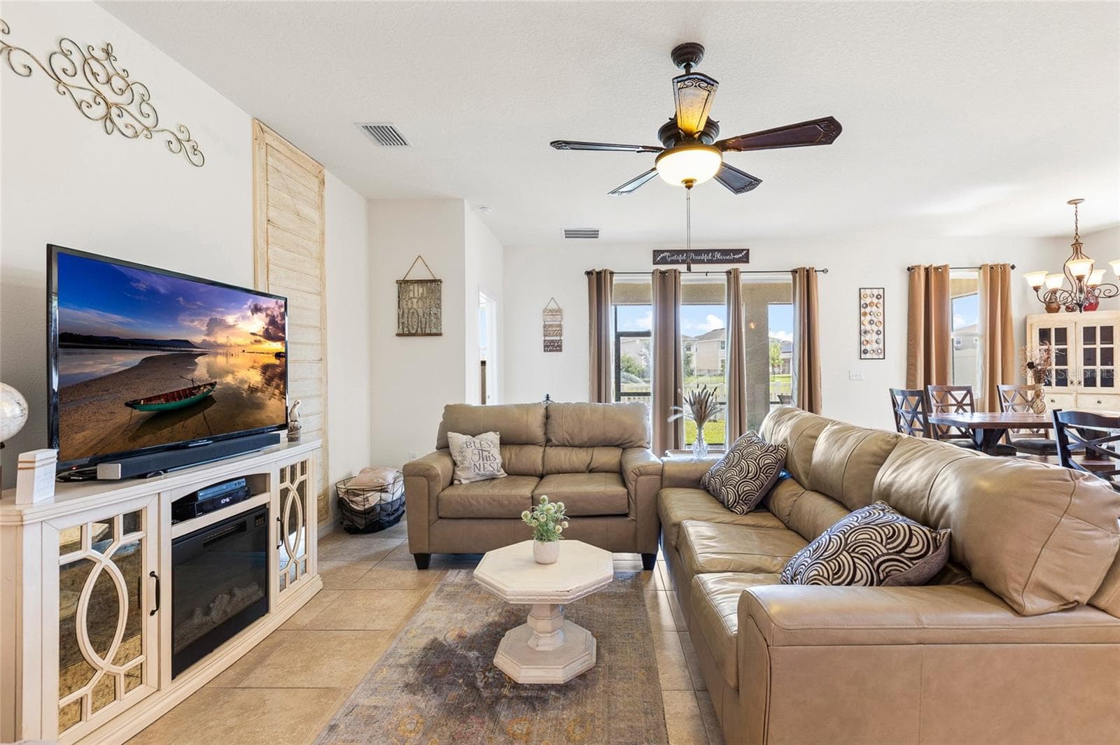 The expansive great room offers an open and inviting layout with plenty of natural light and direct views of the backyard and pond. Perfect for entertaining, relaxing, or spending time with family, this central living space flows effortlessly into the kitchen and dining area, making it ideal for today's lifestyle. - 5025 JACKEL CHASE DR, WIMAUMA