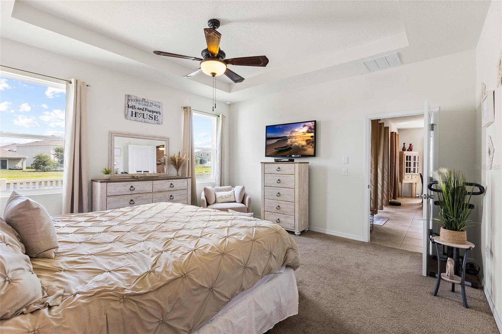 Retreat to the spacious primary suite, featuring tranquil pond views, generous room dimensions, and dual walk-in closets. The private owner's retreat provides a peaceful setting while offering plenty of storage and flexibility for large furniture arrangements. - 5025 JACKEL CHASE DR, WIMAUMA
