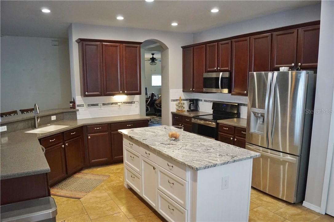 Large kitchen with stainless steel appliances, subway tile backsplash and an updated extra large island - 1742 MIRA LAGO CIR, RUSKIN